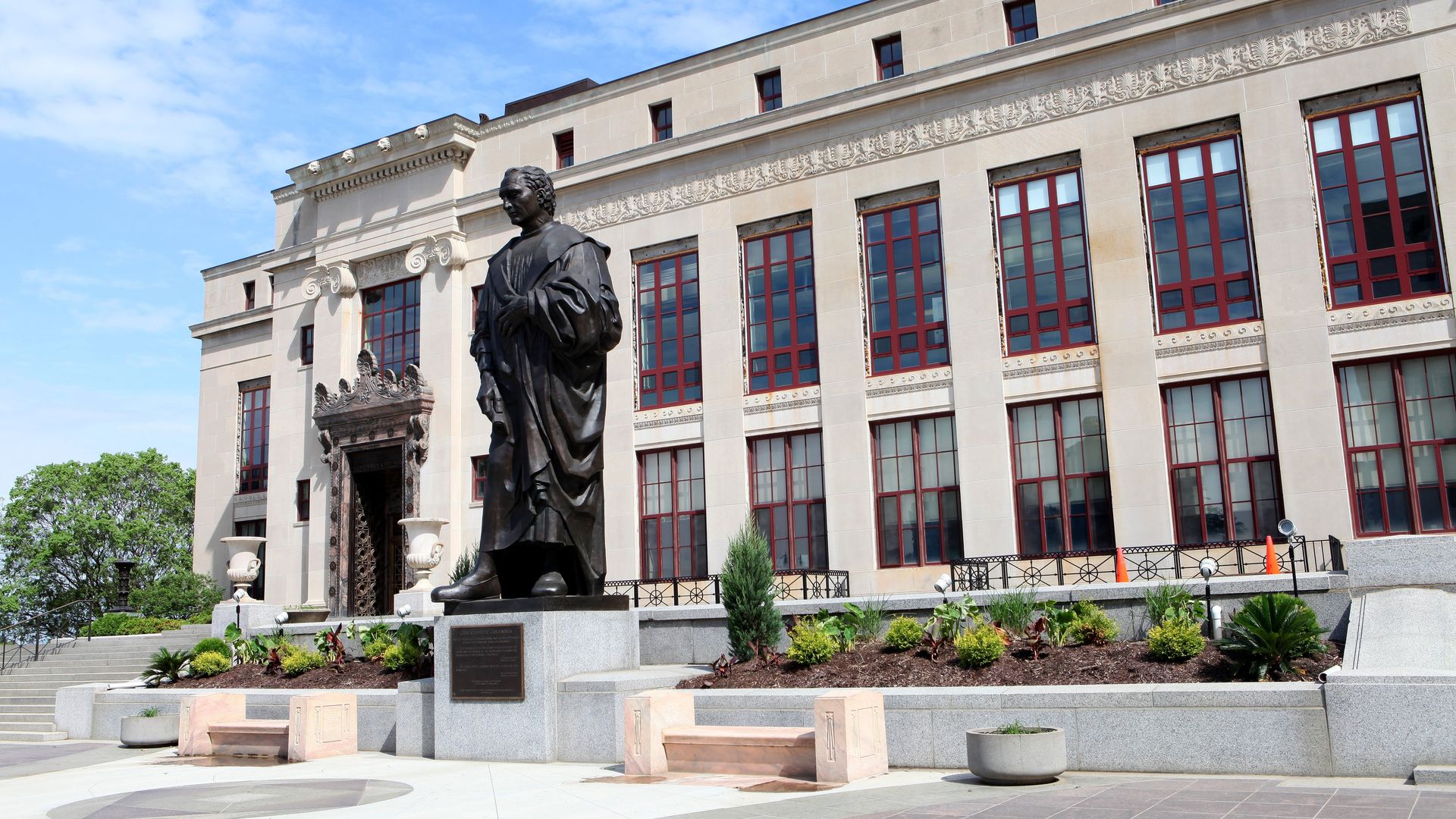 An old photo of Columbus City Hall, with a Christopher Columbus statue in front of it, that has since been removed