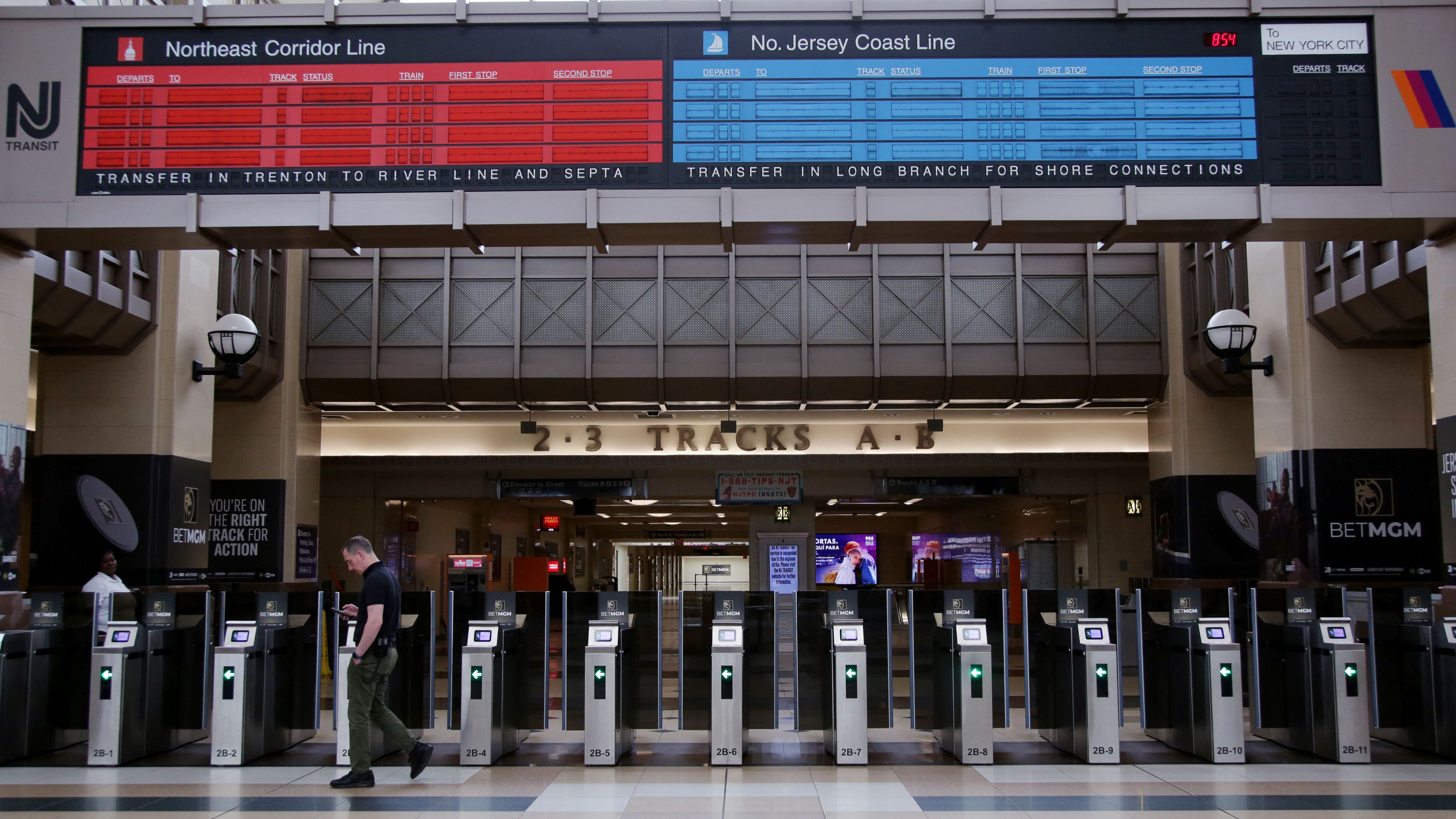 TOPSHOT - A man walks through Secaucus Junction Station in Secaucus, New Jersey, during a transit strike on May 16, 2025. Train services ground to a halt in New Jersey one minute after midnight on May 16, according to the railway operator, as the US state's first mass transit strike in decades took 