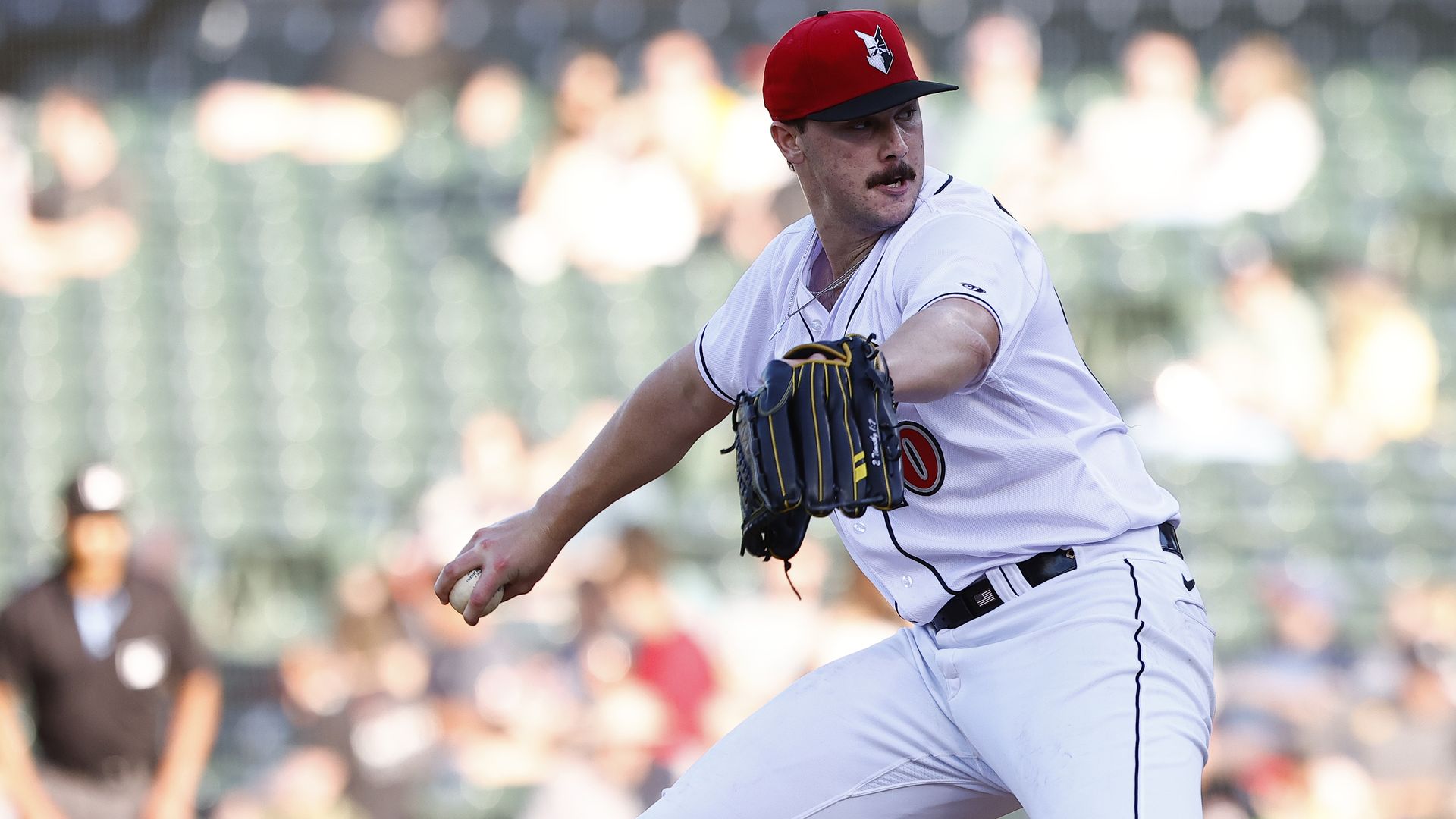 Paul Skenes is photographed mid-throw as he angles his body back to throw a baseball.