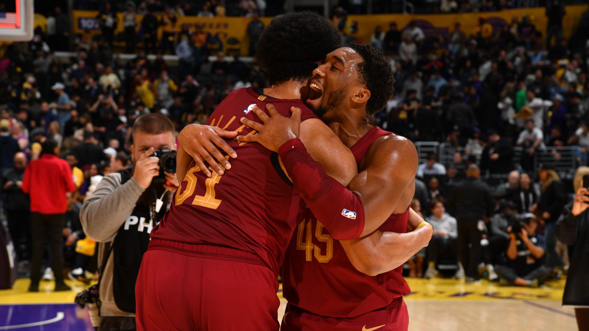 The Cavs Donovan Mitchell and Jarrett Allen embrace in red jerseys