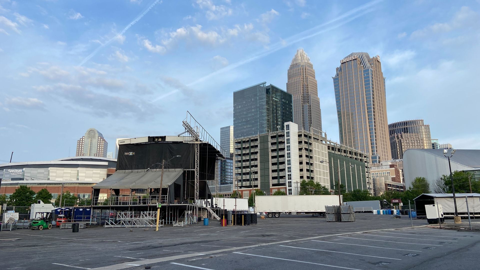 construction of a stage with the Charlotte skyline in the background