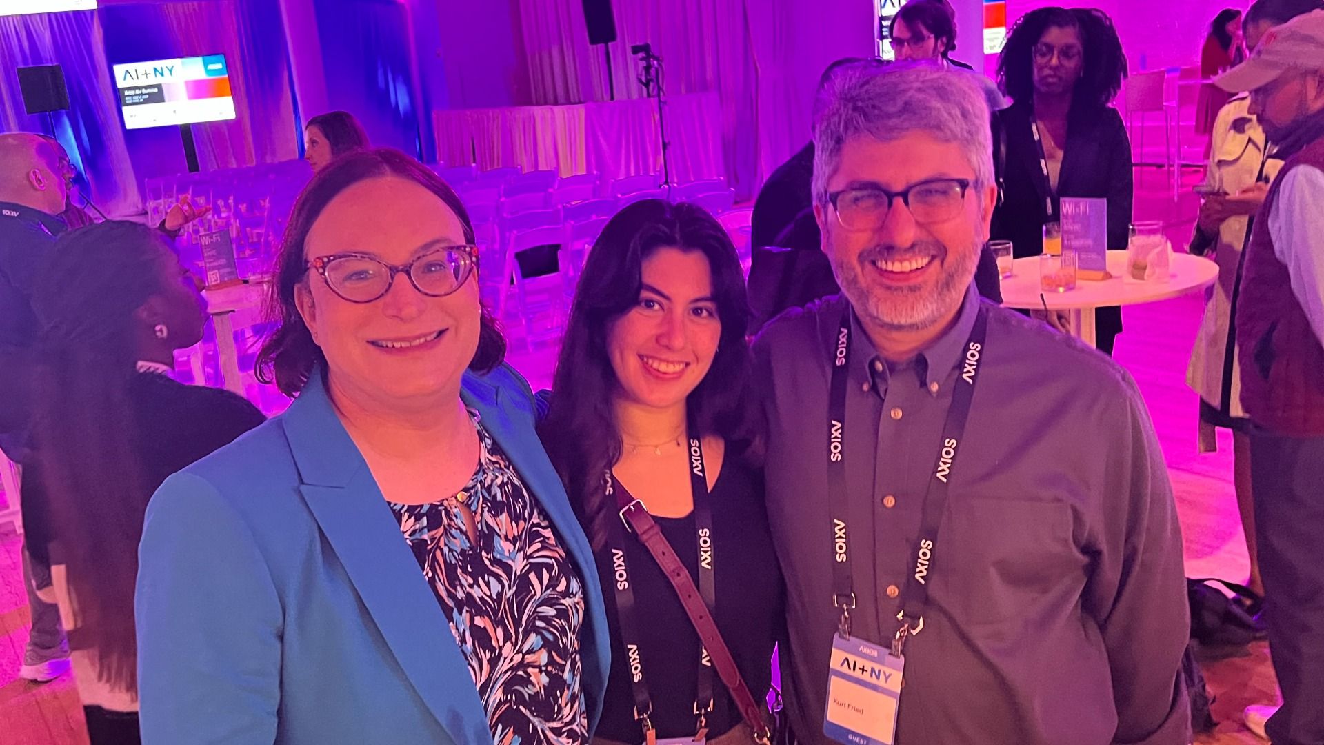 Three people standing together at a tech conference.