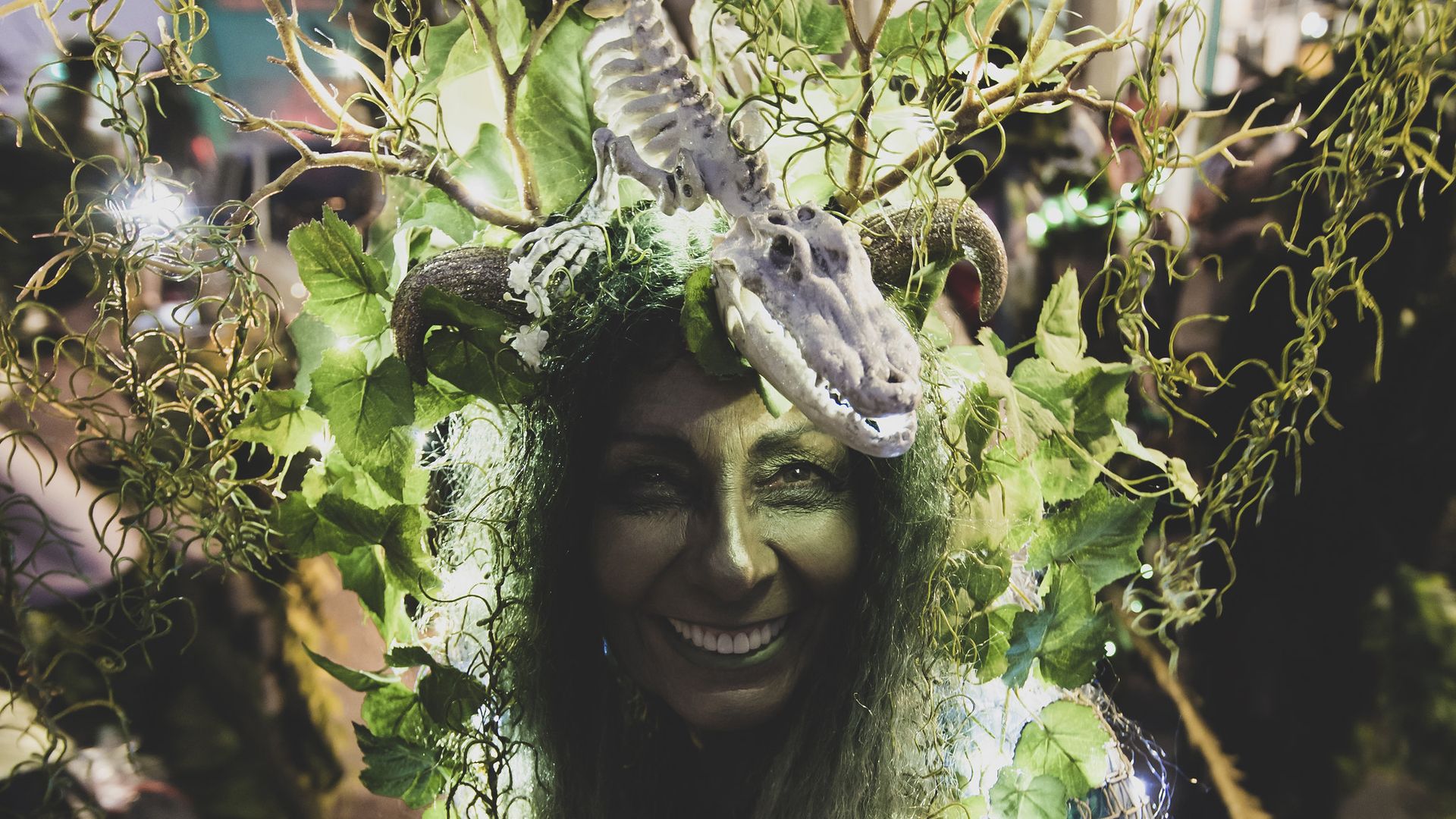 Image shows a woman dressed in a swampy costume.