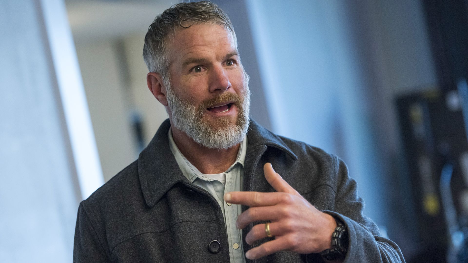 Brett Favre, former quarterback for the Green Bay Packers, speaks to a reporter.