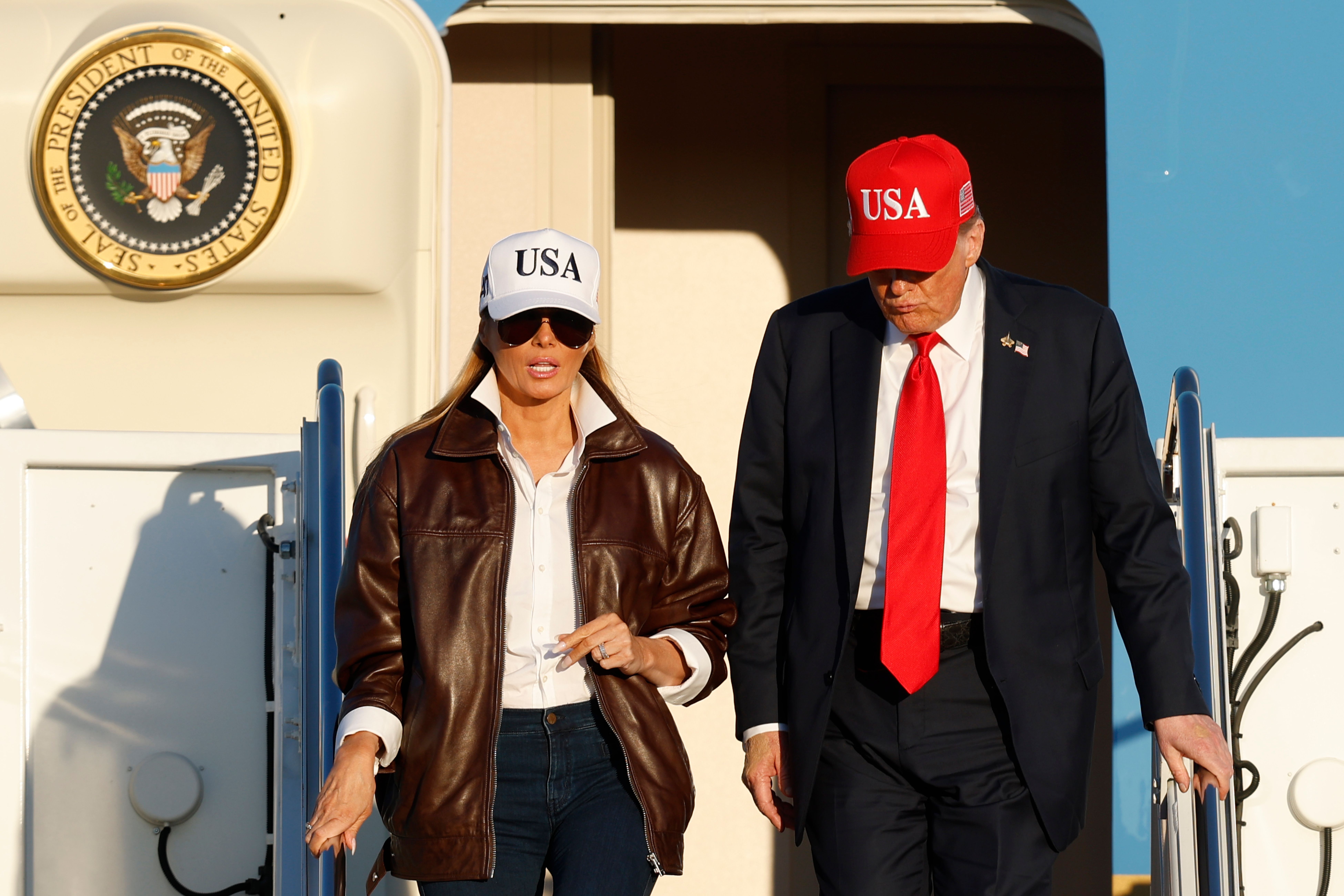 President Trump and First Lady Melania Trump walk off Air Force One at Joint Base Andrews after returning from Norfolk, Va., on Sunday.