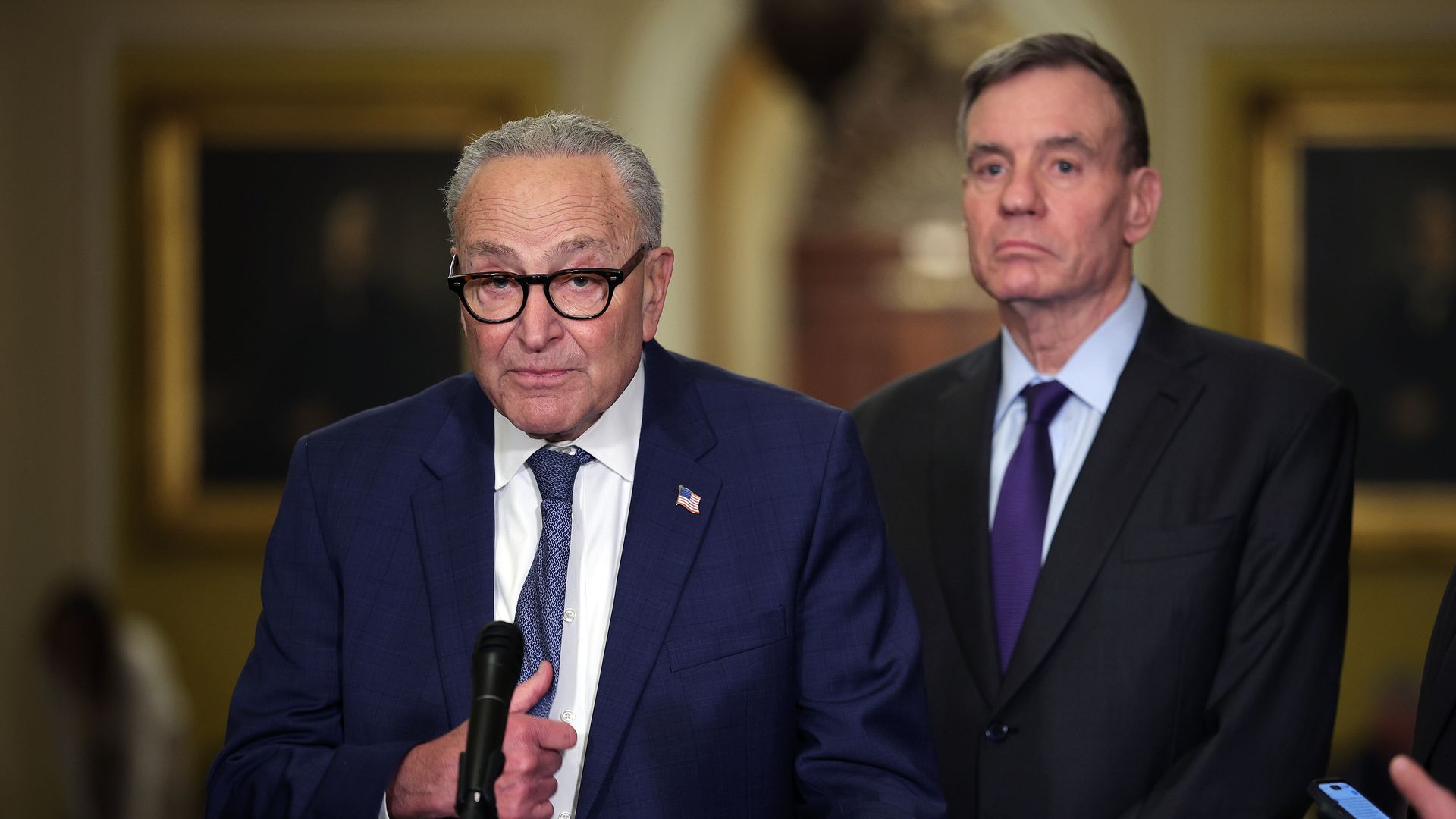 Senate Minority Leader Chuck Schumer, joined by Intelligence Committee Chair Mark Warner, speaks during a news conference at the U.S. Capitol on Jan. 6.