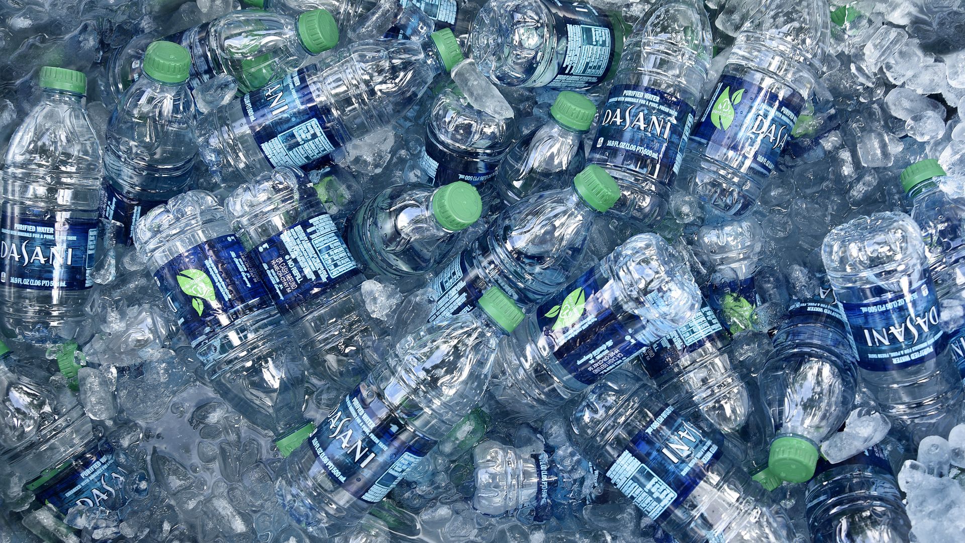 A tub filled with ice and plastic bottles of Dasani purified bottled water 