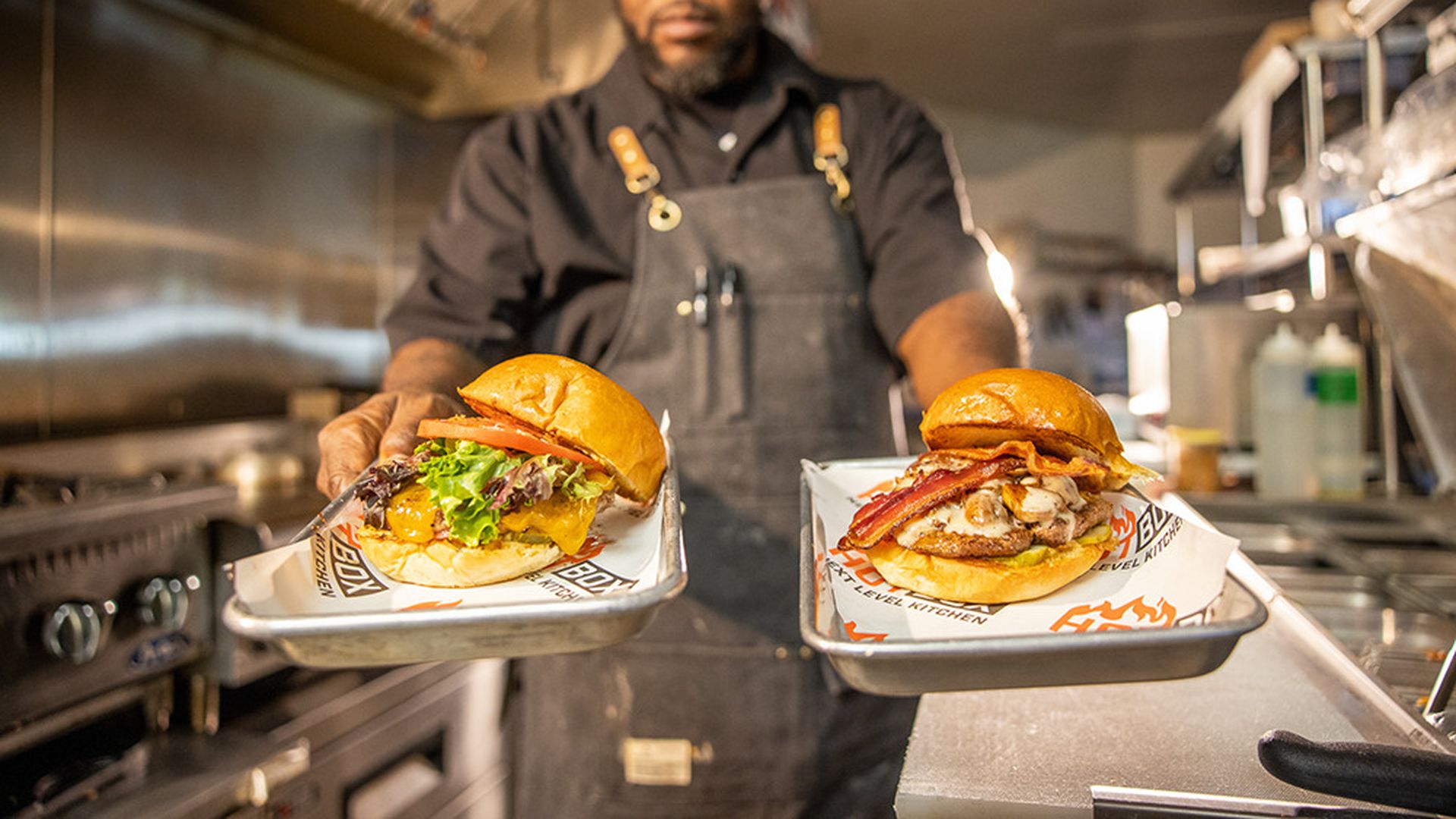 Chef Michael Bowling serving Hot Box Next Level Kitchen burgers. Photo: Peter Taylor/courtesy of Hot Box Next Level Kitchen