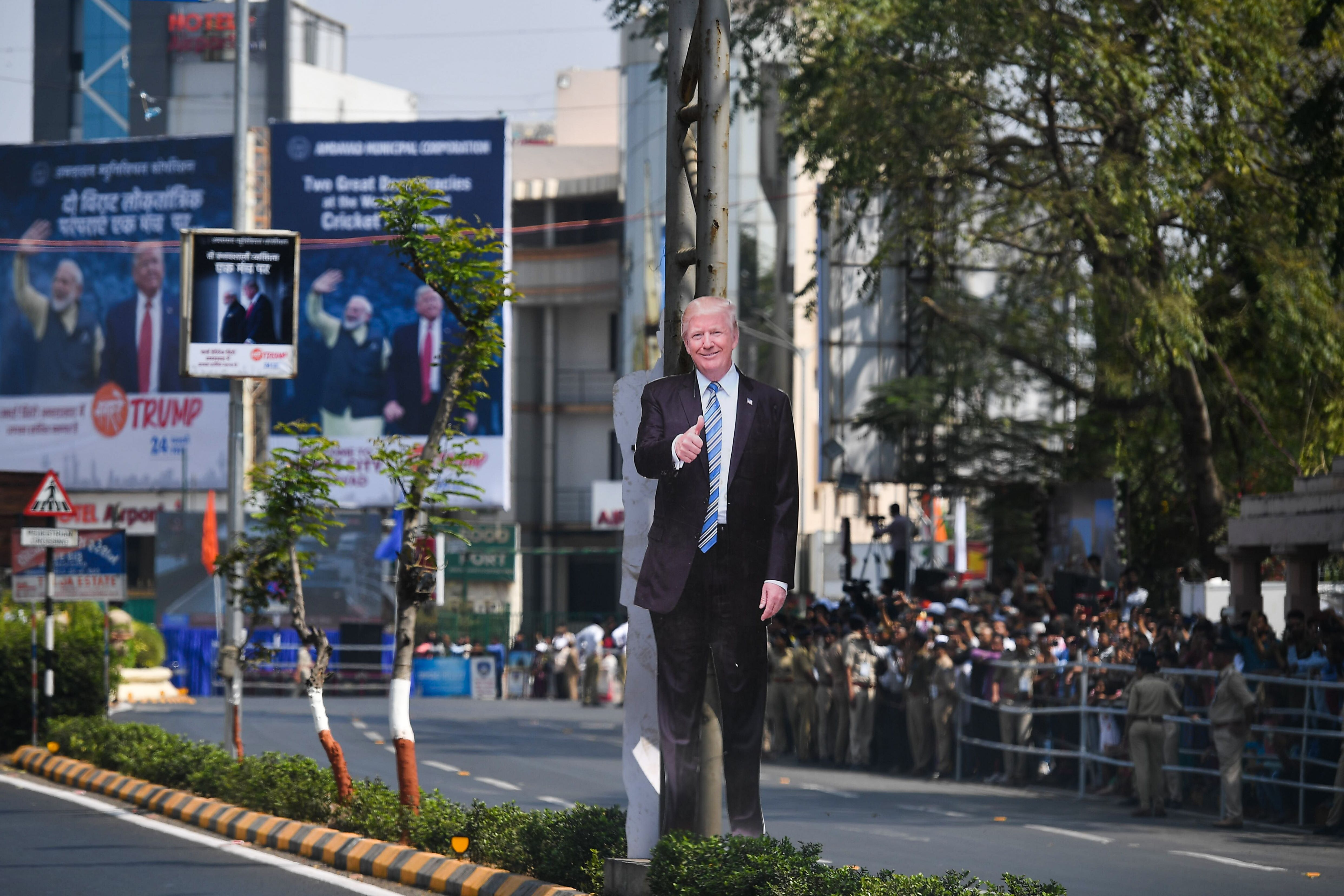  A cutout of US President Donald Trump is seen as people wait beside a street to catch a glimpse of his motorcade in Ahmedabad on February 24