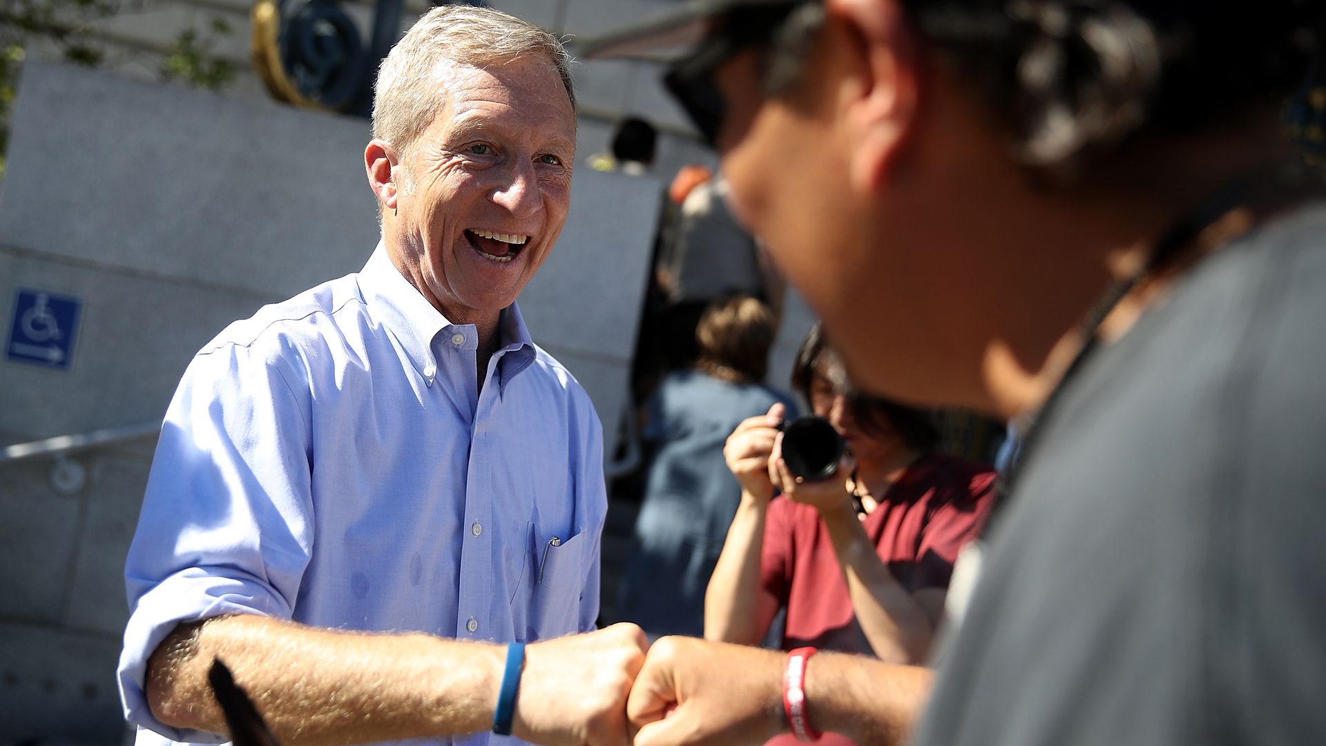 Tom Steyer talking to people at a rally