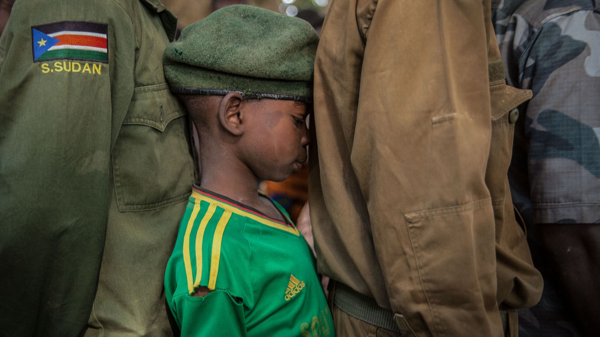 Newly released child soldiers wait in a line for their registration