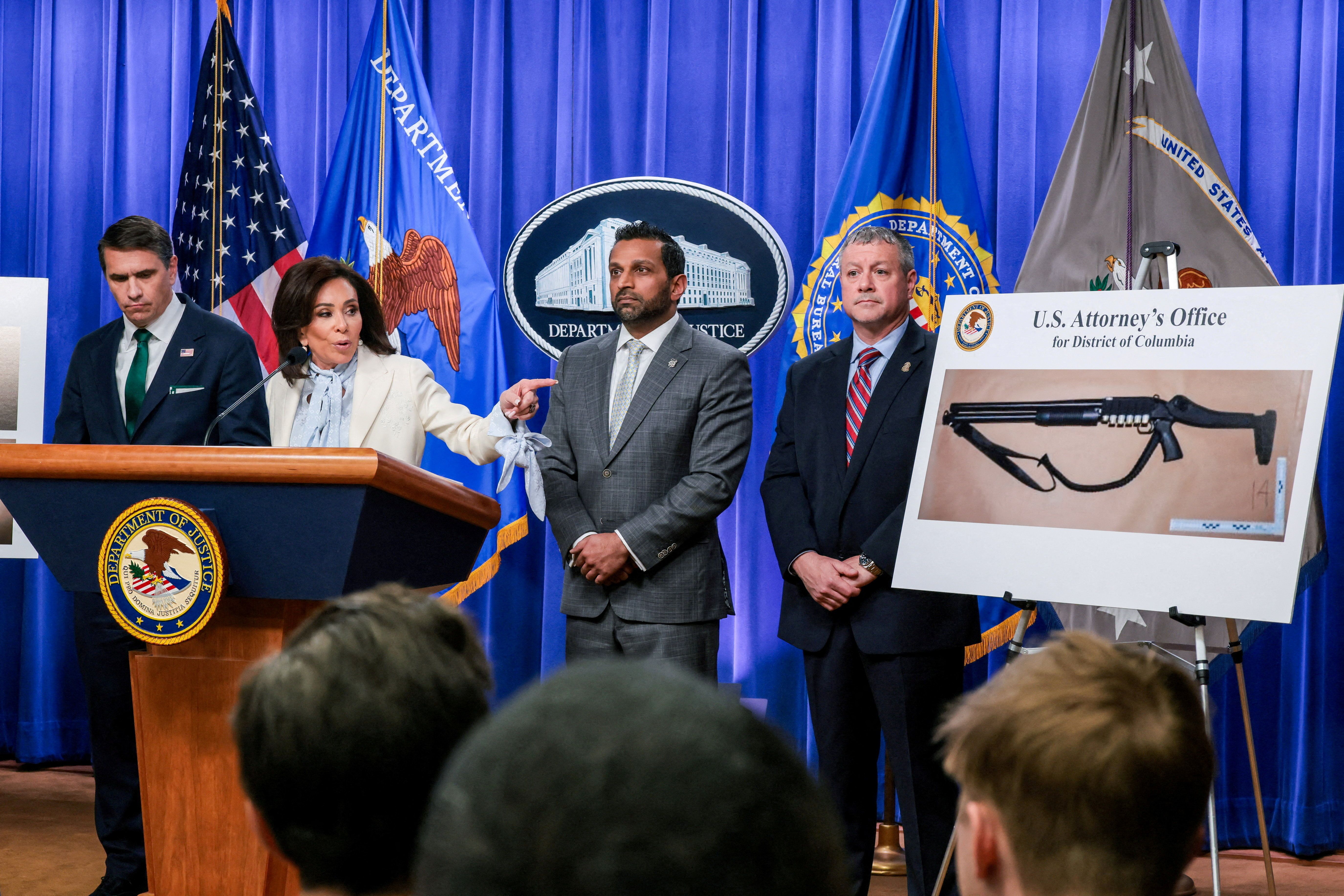 Jeanine Pirro, U.S. attorney for D.C., points at a picture of a shotgun carried by shooting suspect Cole Tomas Allen at a press conference yesterday. 