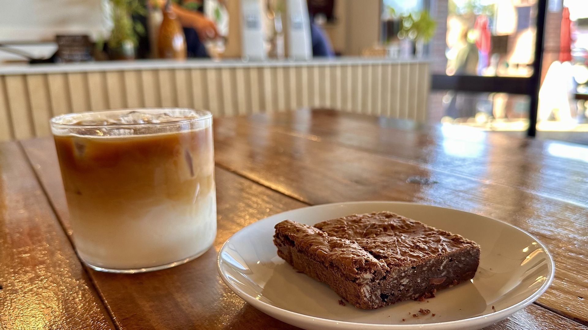 A photo of a layered coffee drink and a brownie
