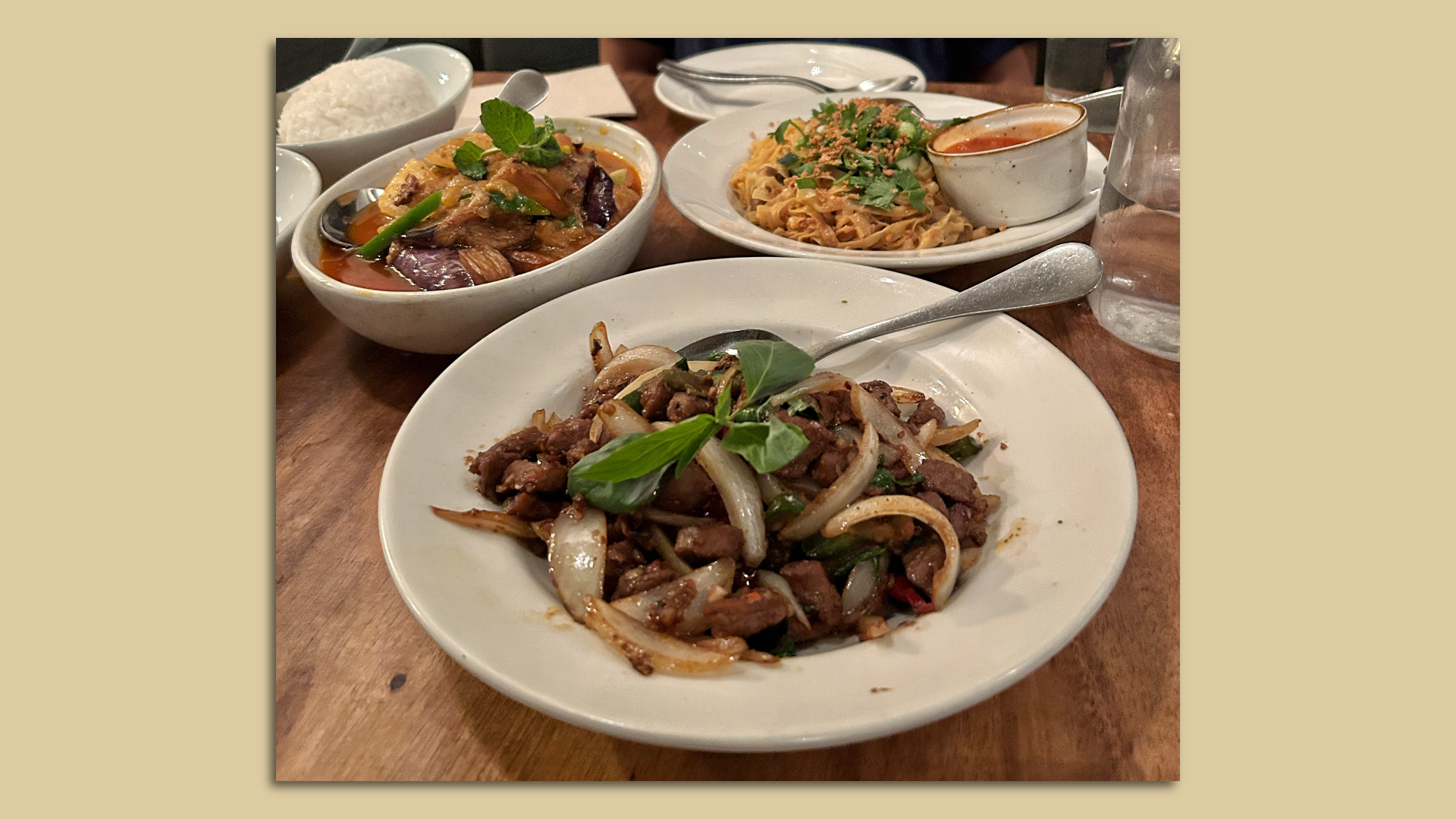 Photo of three Burmese dishes: an eggplant curry, sautéed beef and tofu garlic noodles