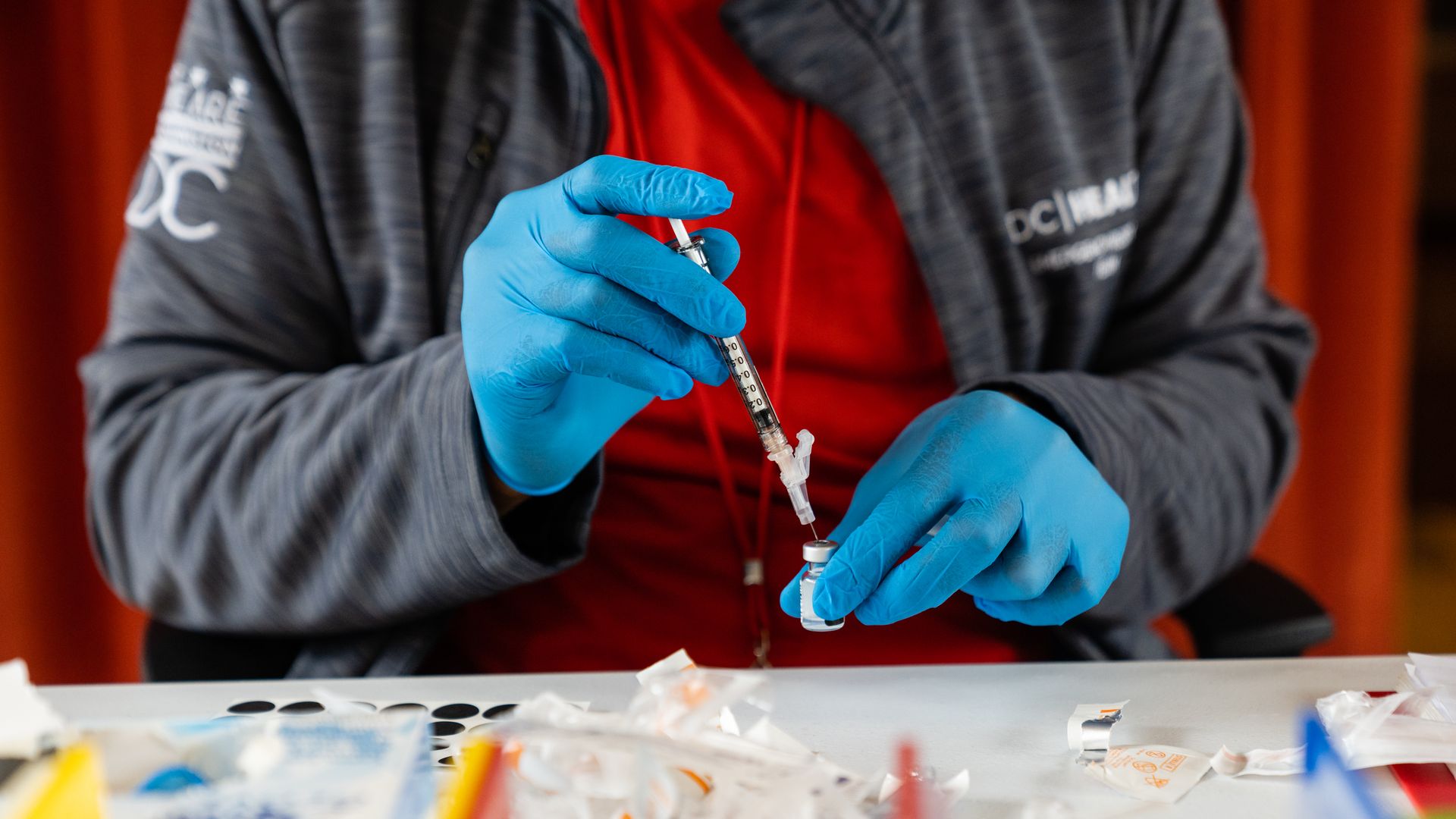 nurse, prepares a syringe with a Covid-19 vaccine