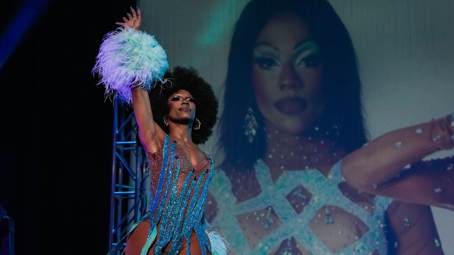 Photo of a drag queen on stage in blue