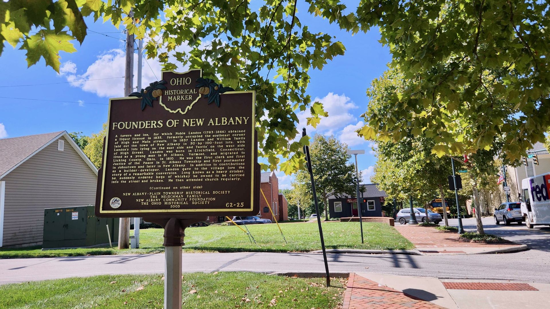 A historical marker reading "Founders of New Albany" flanked by a green tree