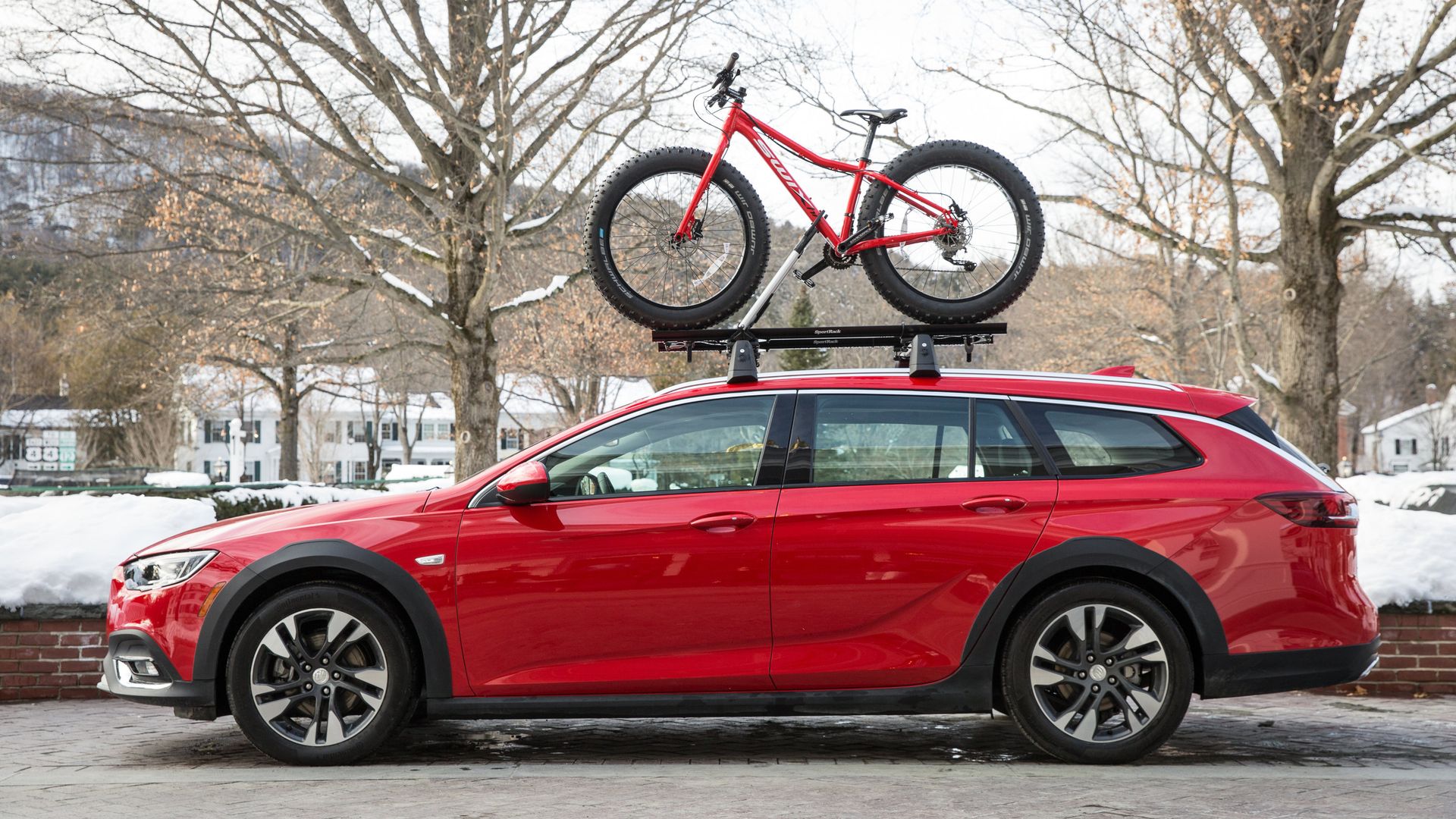 Image of a Buick Regal TourX wagon with a bicycle on the roof rack. 
