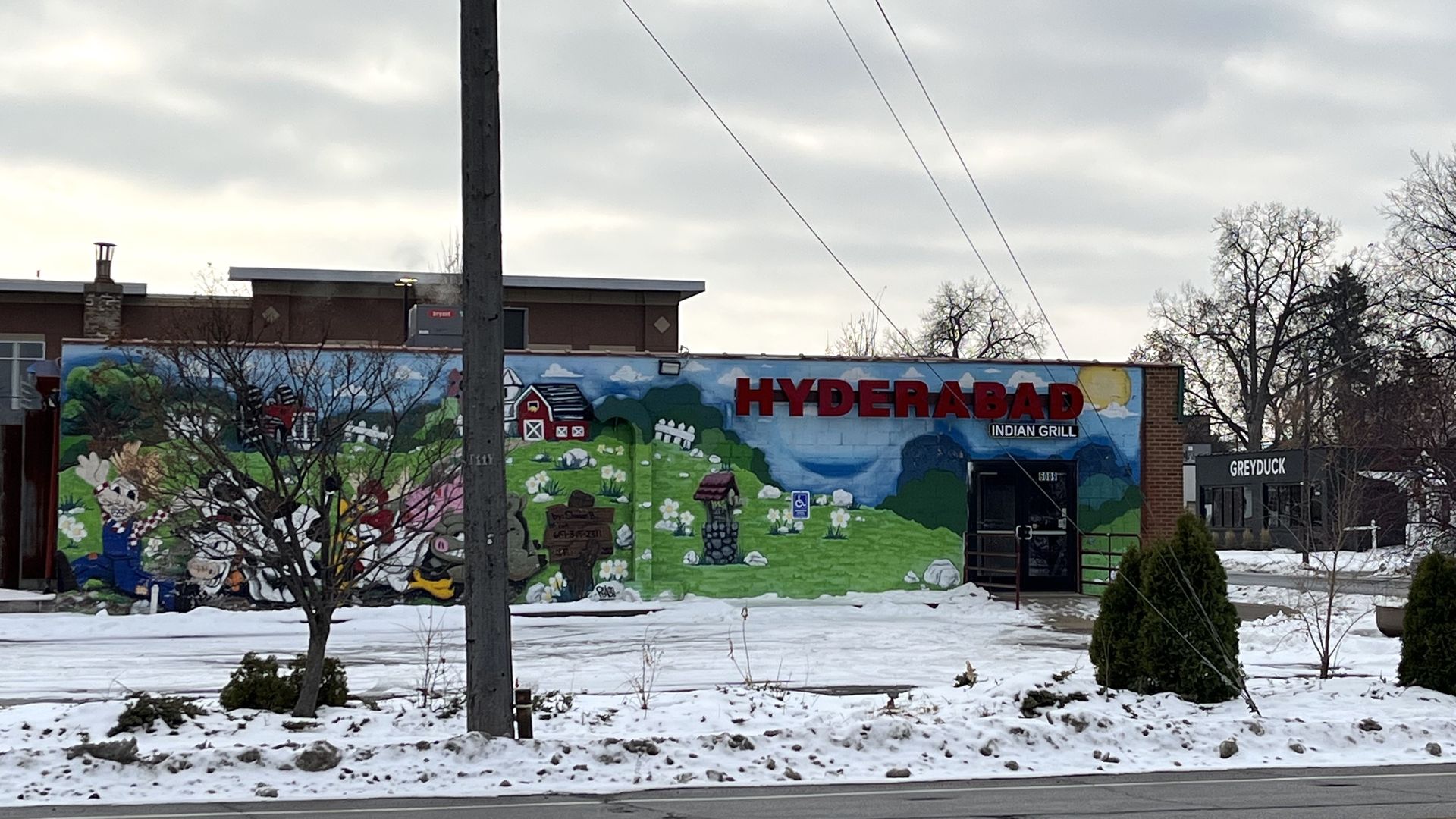 A restaurant building with Hyderabad indian grill on the side 