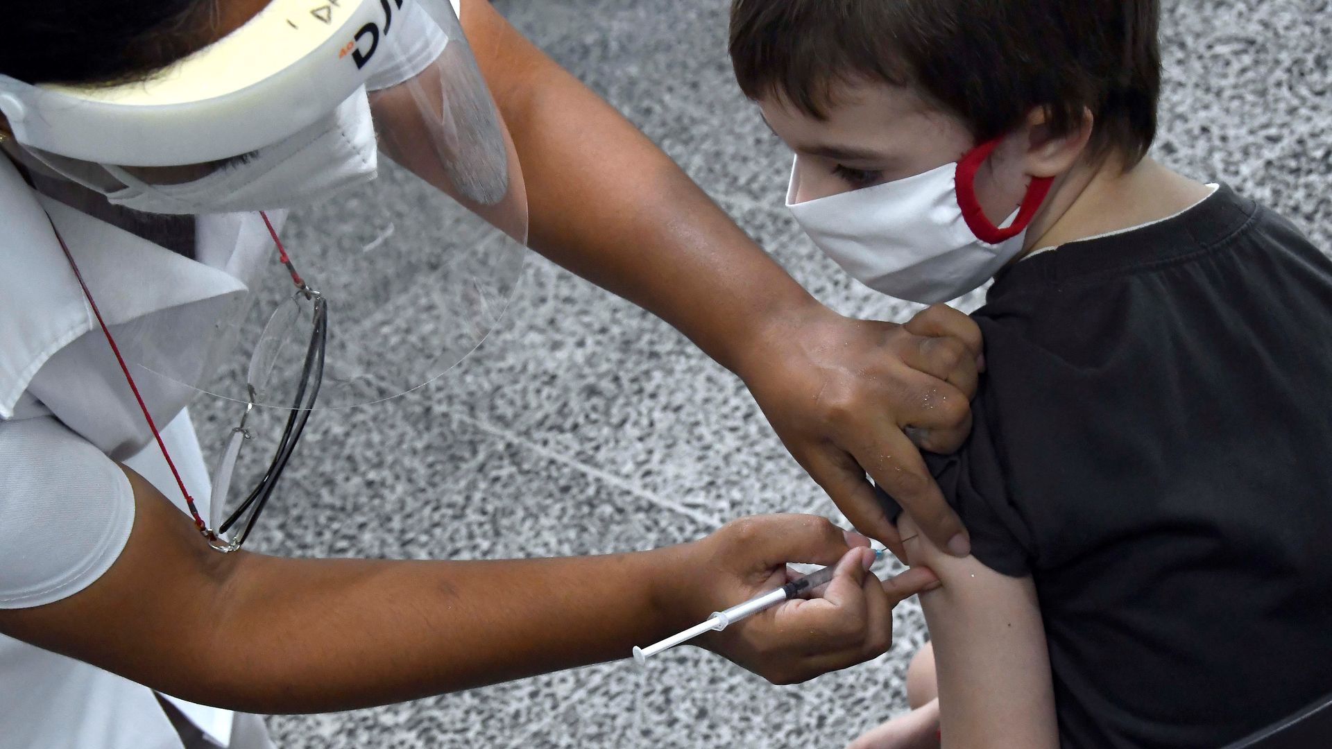 A child receives a dose of COVID-19 vaccine at a school in Havana, Cuba, Sept. 16, 2021. 