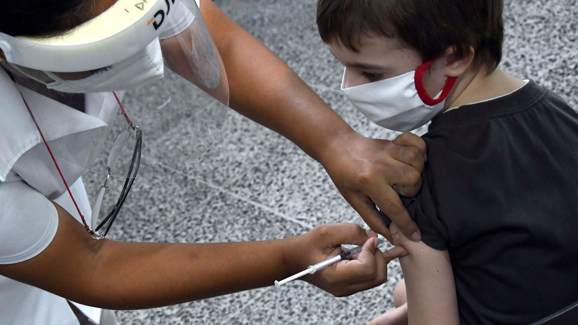 A child receives a dose of COVID-19 vaccine at a school in Havana, Cuba, Sept. 16, 2021.