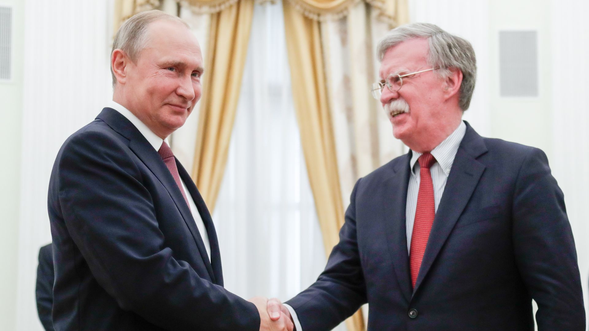 JUNE 27, 2018: Russia's President Vladimir Putin (L) and US National Security Adviser John Bolton shake hands during a meeting in the Kremlin. 