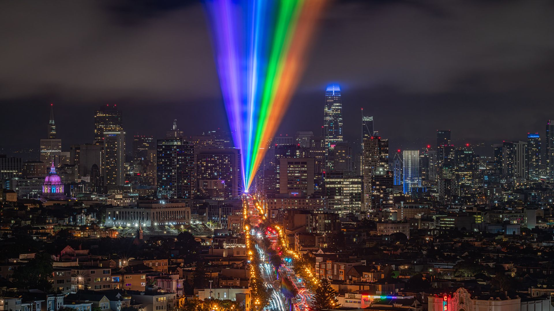 A rainbow light is blasted into the night sky in San Francisco