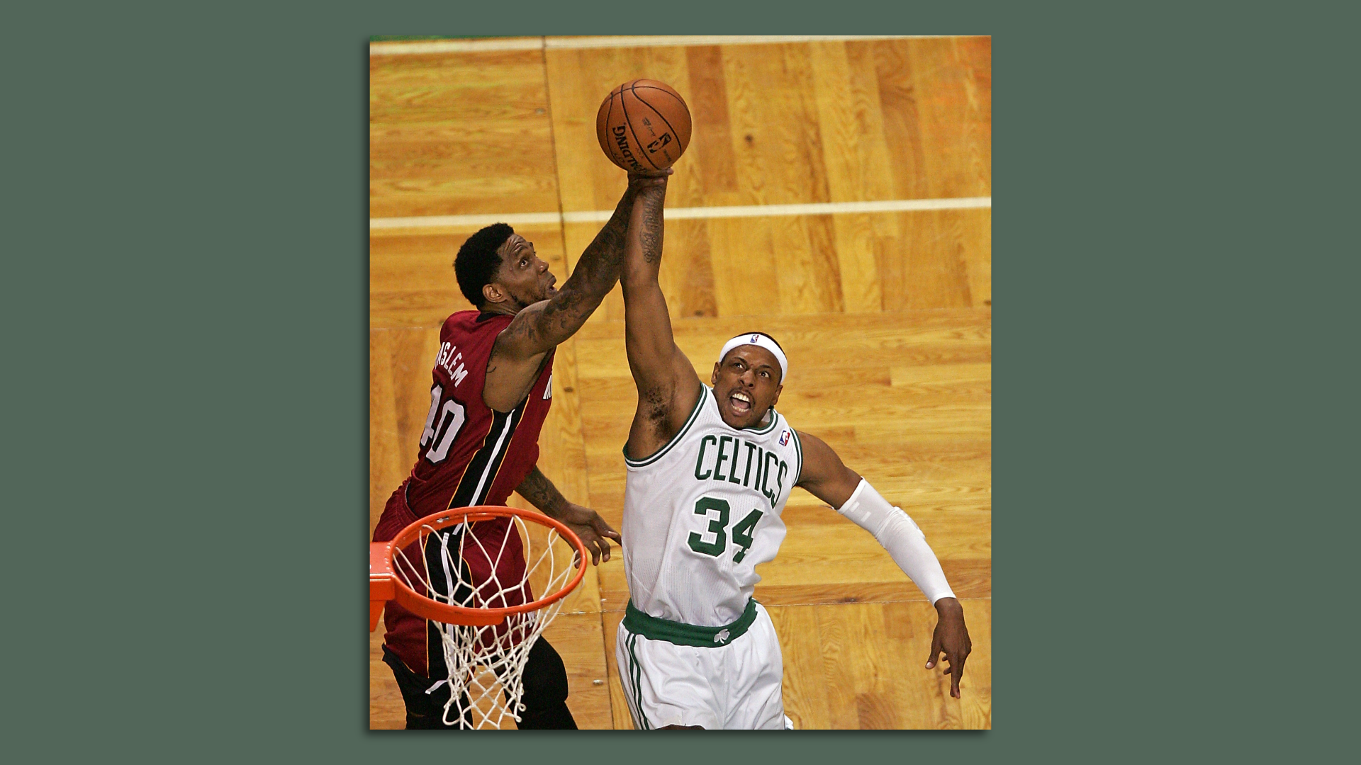 Udonis Haslem swipes at the ball as Paul Pierce drives to the basket.