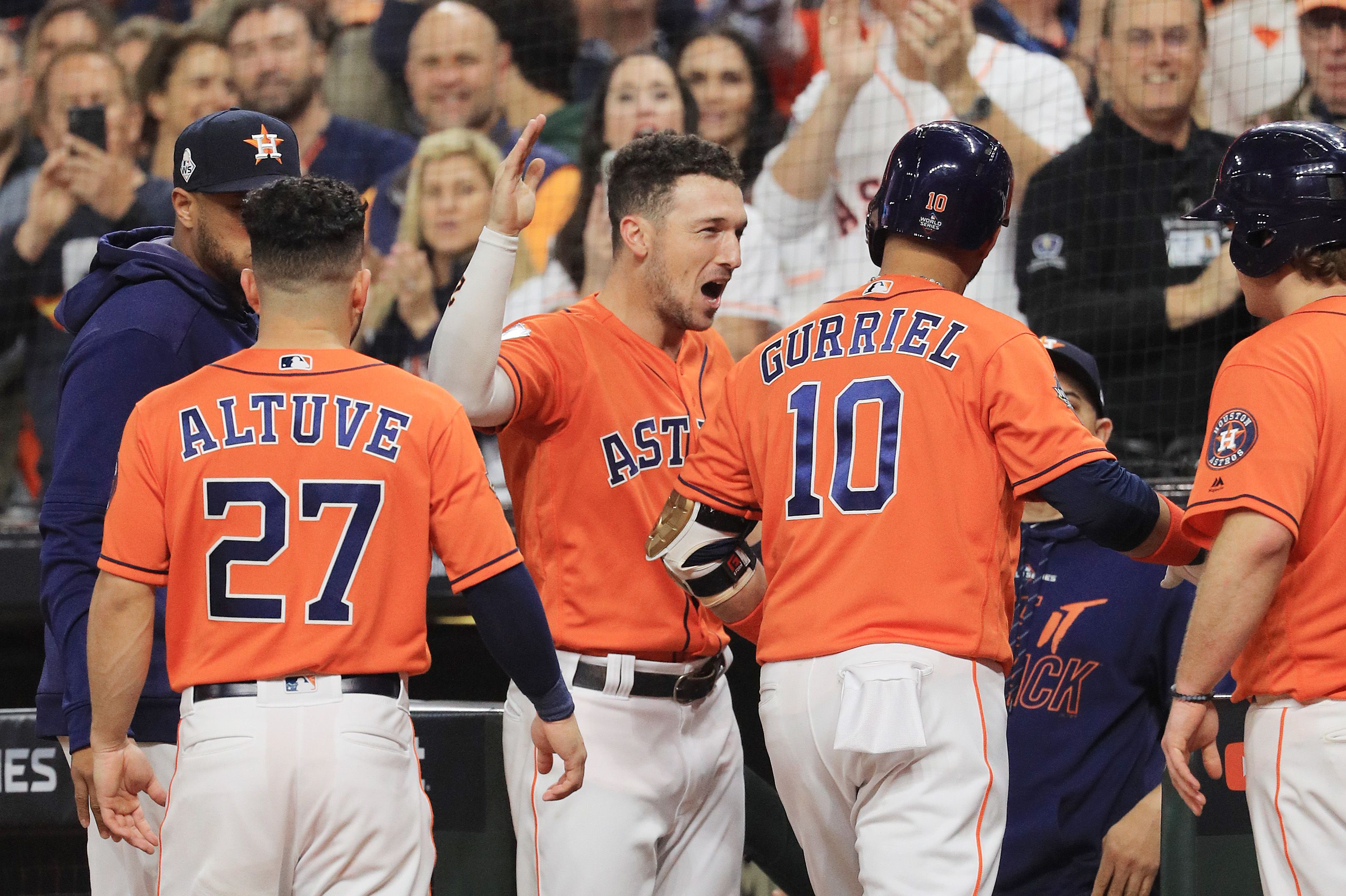 Yuli Gurriel #10 of the Houston Astros is congratulated by his teammate Alex Bregman #2 after hitting a solo home run against the Washington Nationals 