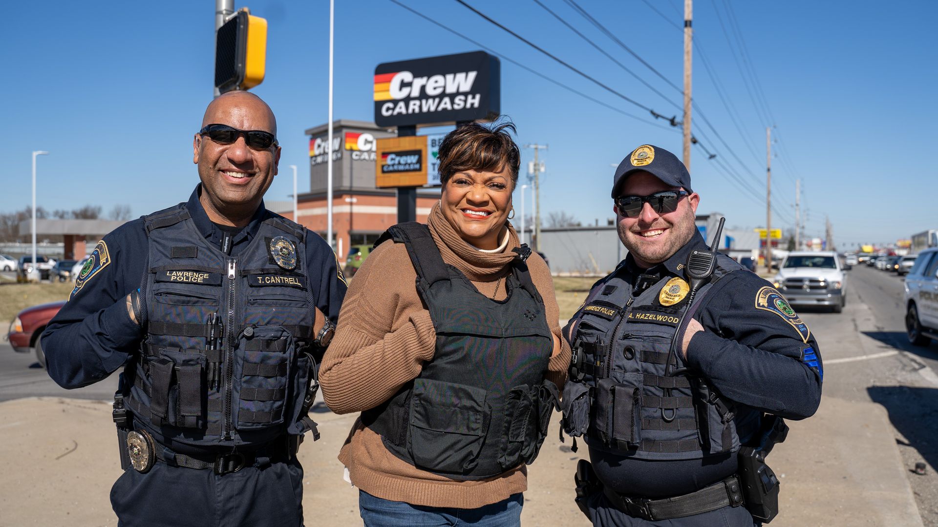Lawrence mayor with two police officers. 