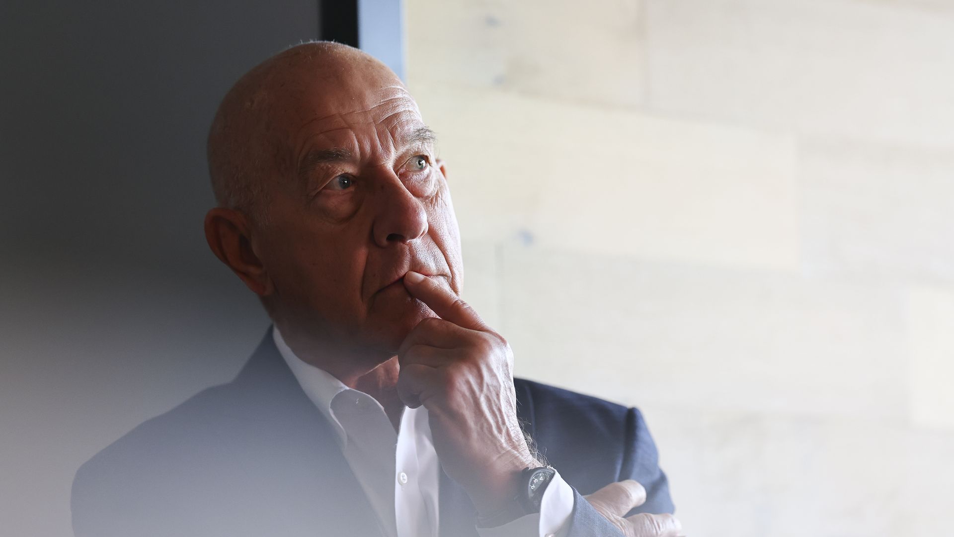 Houston Mayor John Whitmire holds his hand to his mouth as he looks on during a press conference