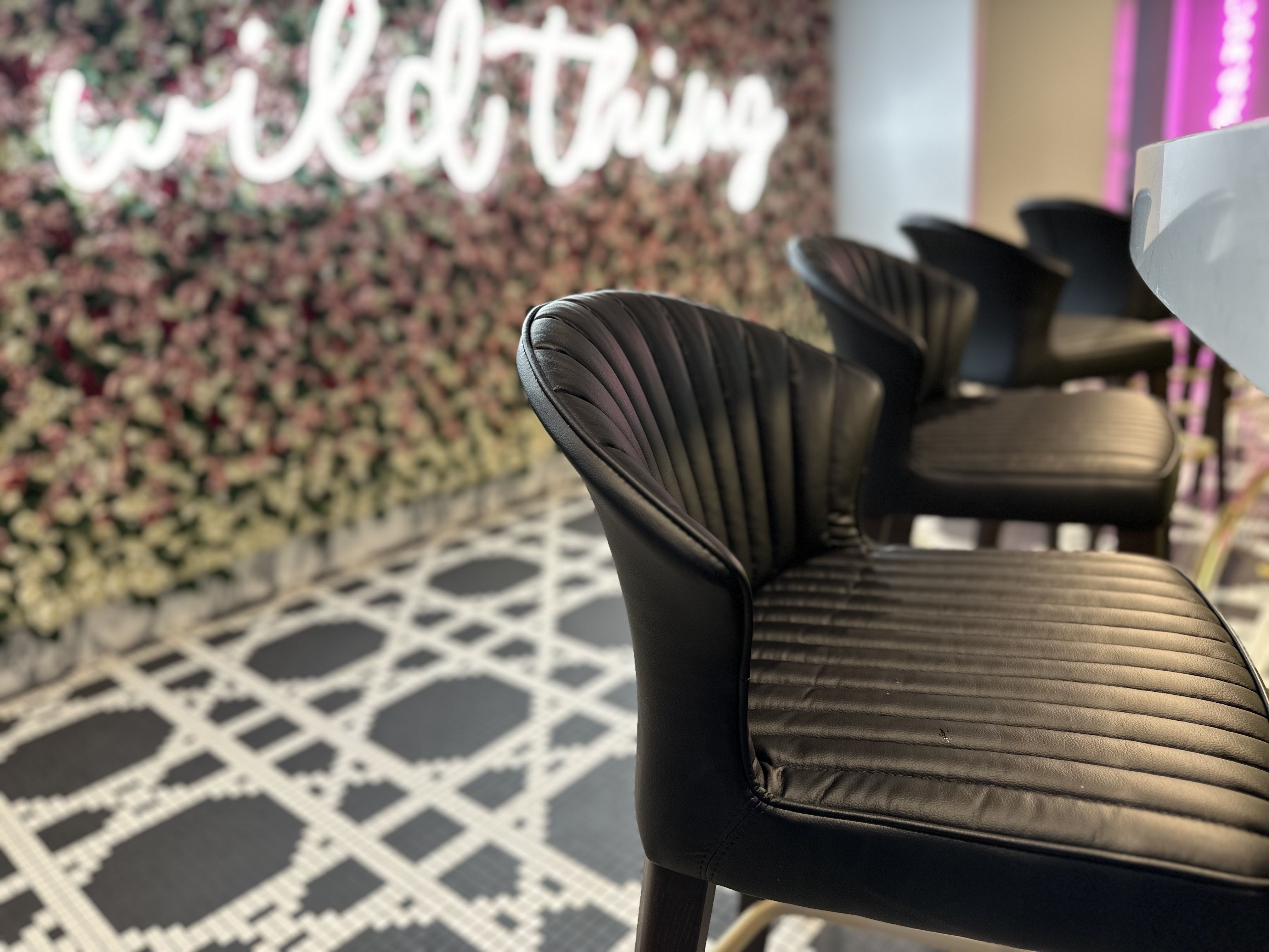 Black leather seats on the first floor of the Sugar Factory in Boston.