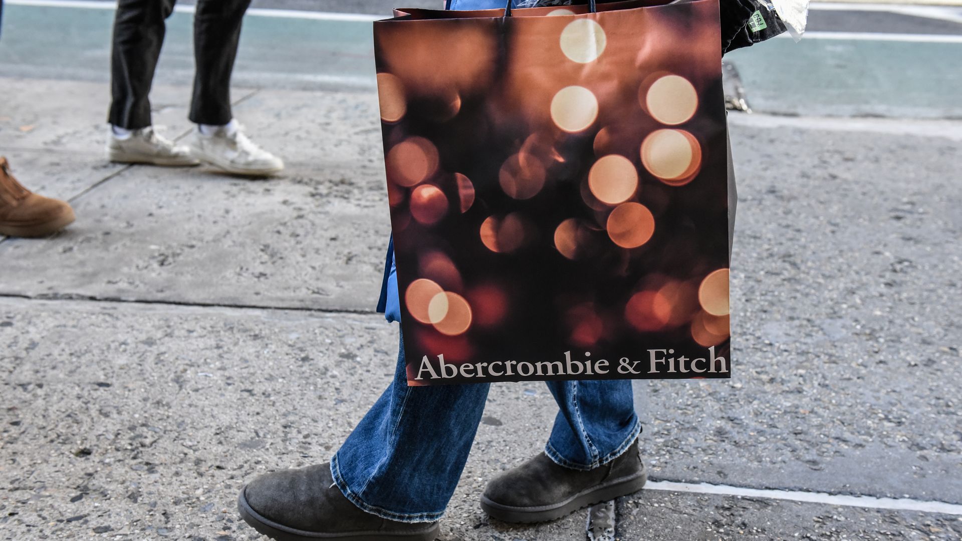 A shopper holds an Abercrombie & Fitch bag. 