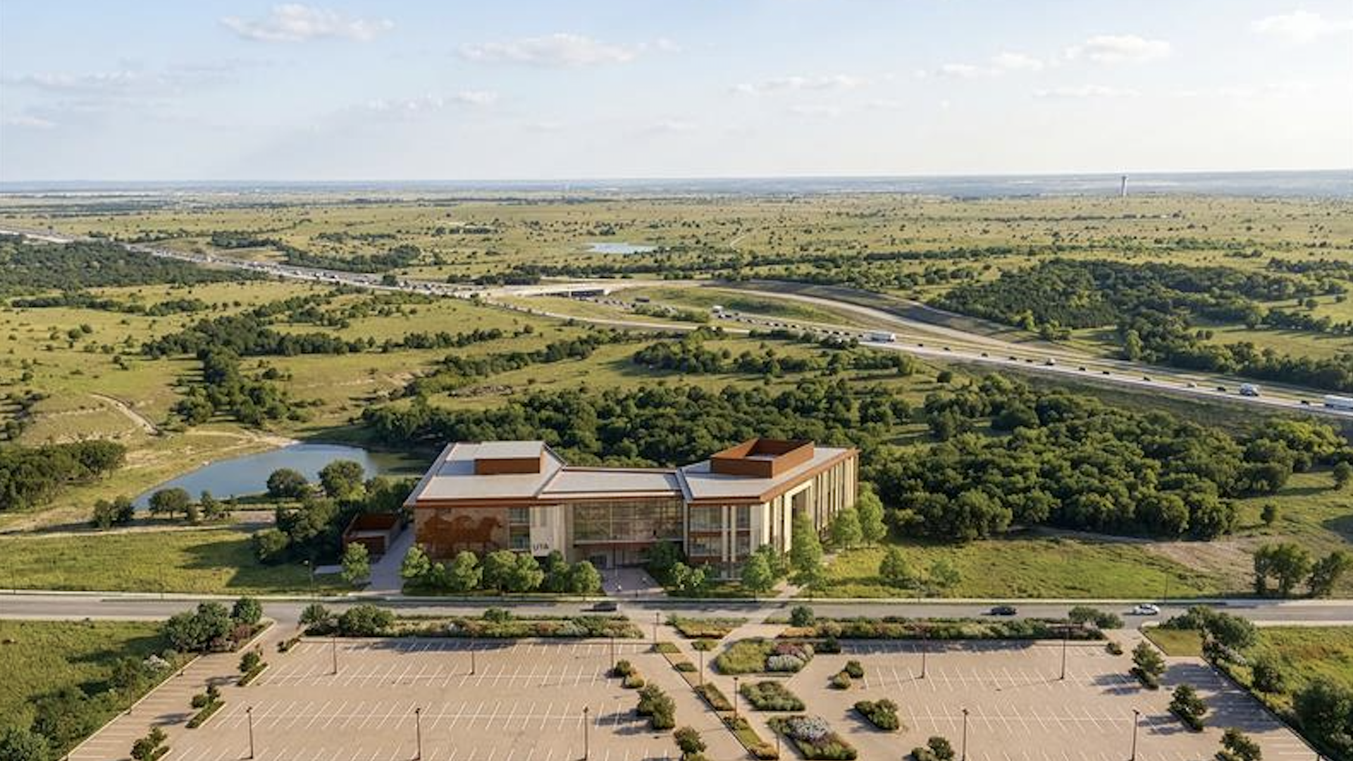 A rendering of an orange building in the middle of green space with a highway behind it 