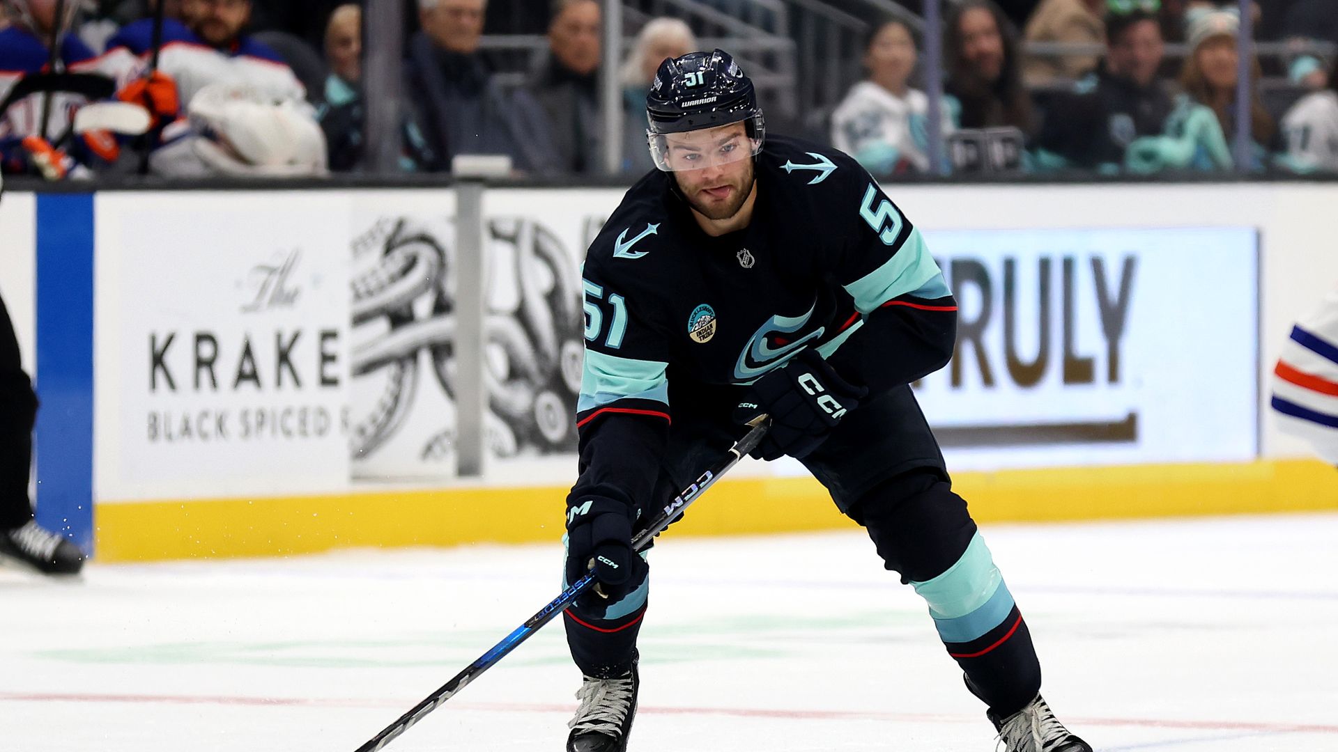 A Seattle Kraken hockey player skates during a preseason game in Seattle. 