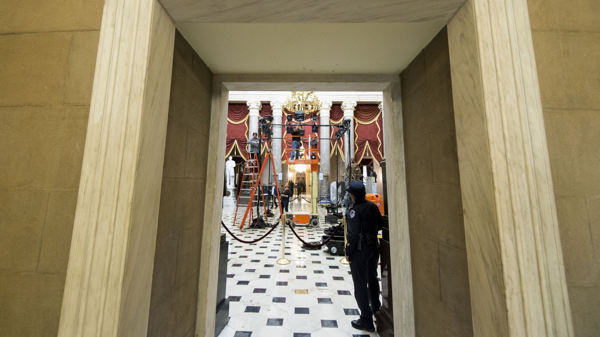 A lighting crew sets up TV lights in Statuary Hall.