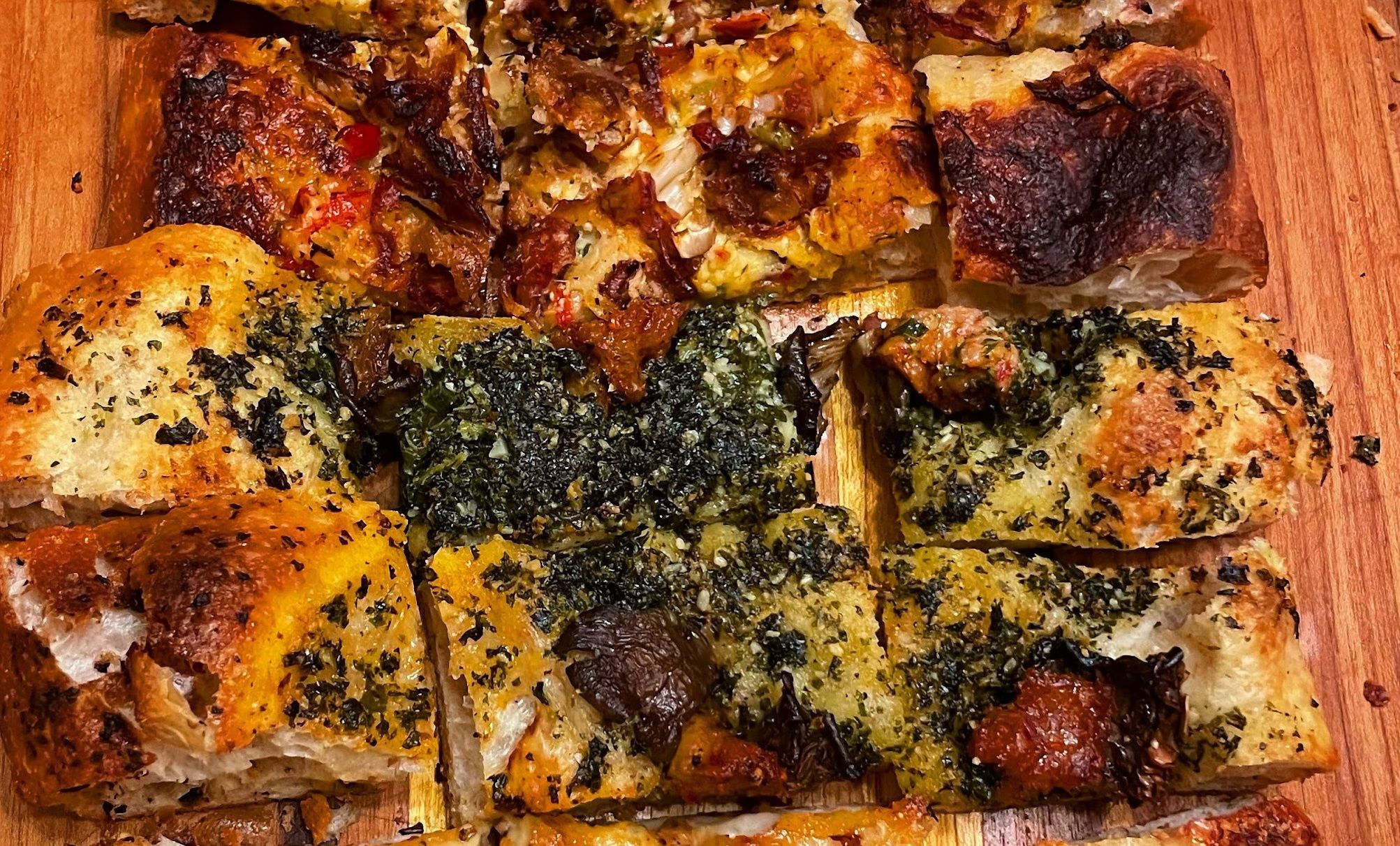 A photo of crispy Roman style pizza.