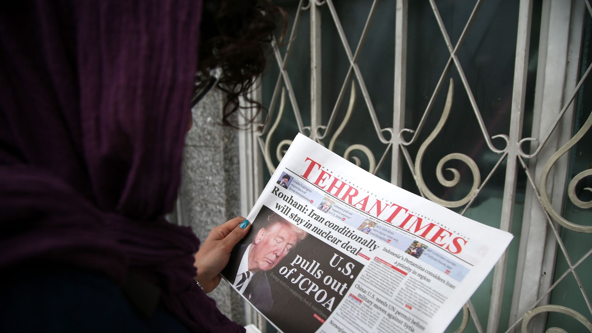 A woman reads Tehran Times on May 9, 2018 in Tehran, Iran. US President Donald Trump announced 'withdrawal' from Iran nuclear deal on May 9, 2018.
