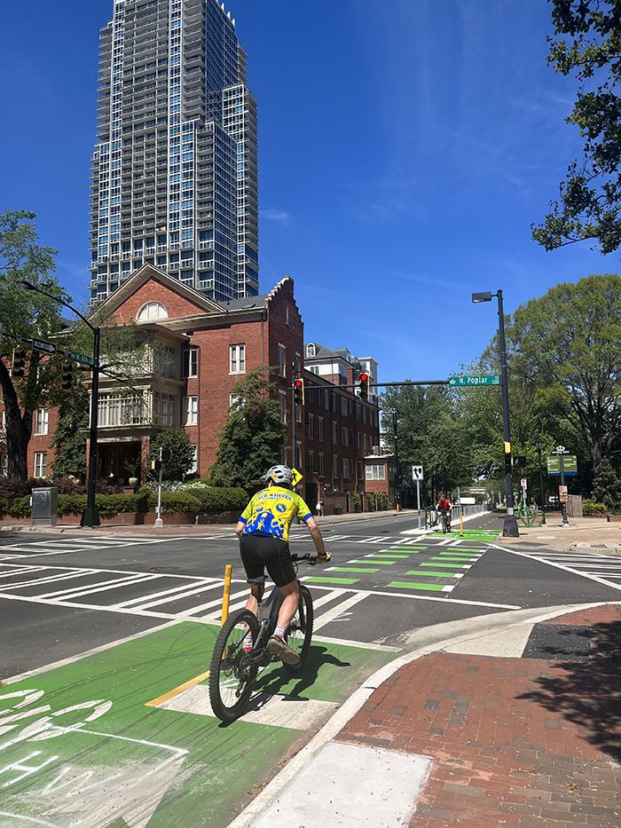 bikers using new protected bike lanes in uptown