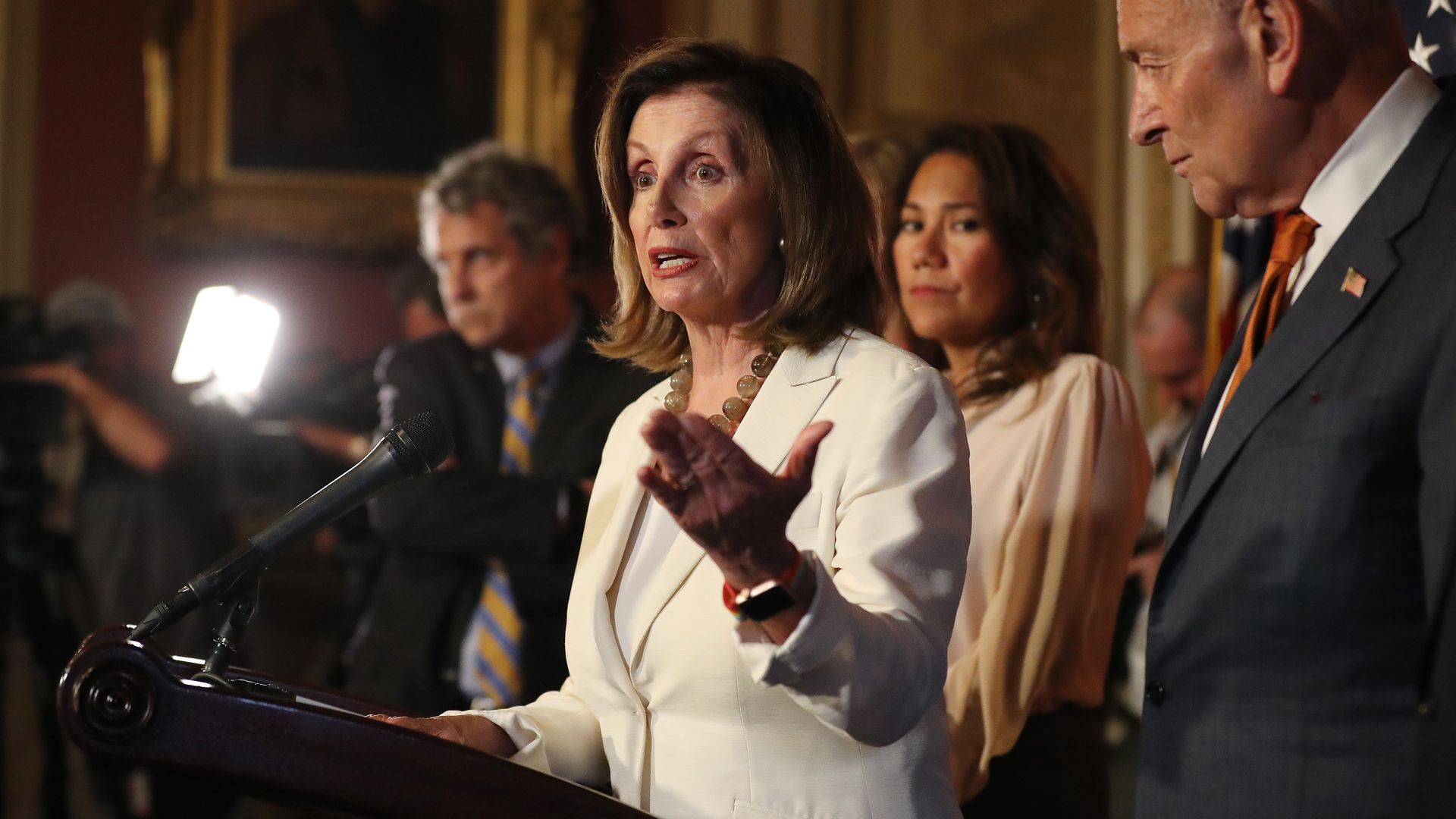 Nancy Pelosi gestures at a press conference