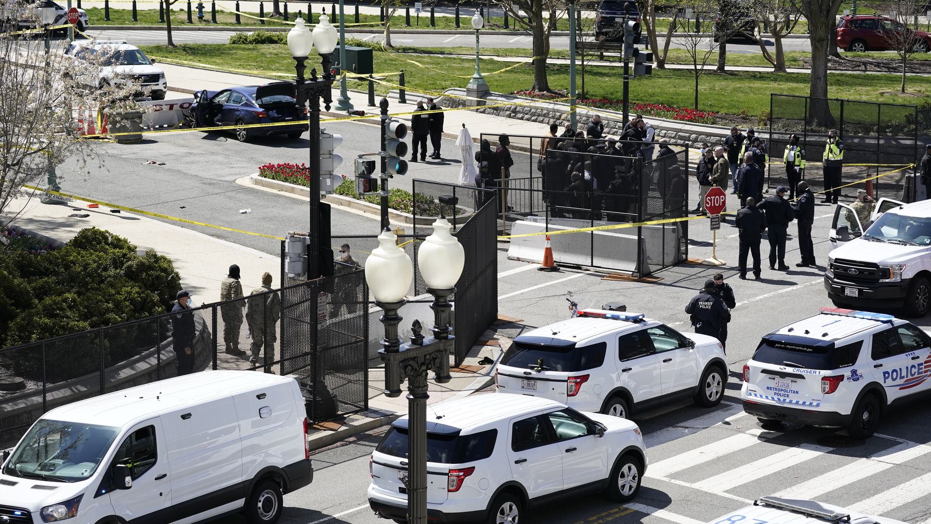 Police officers gather near a car that crashed into a barrier on Capitol Hill in Washington, Friday, April 2, 2021. (AP Photo/J. Scott Applewhite