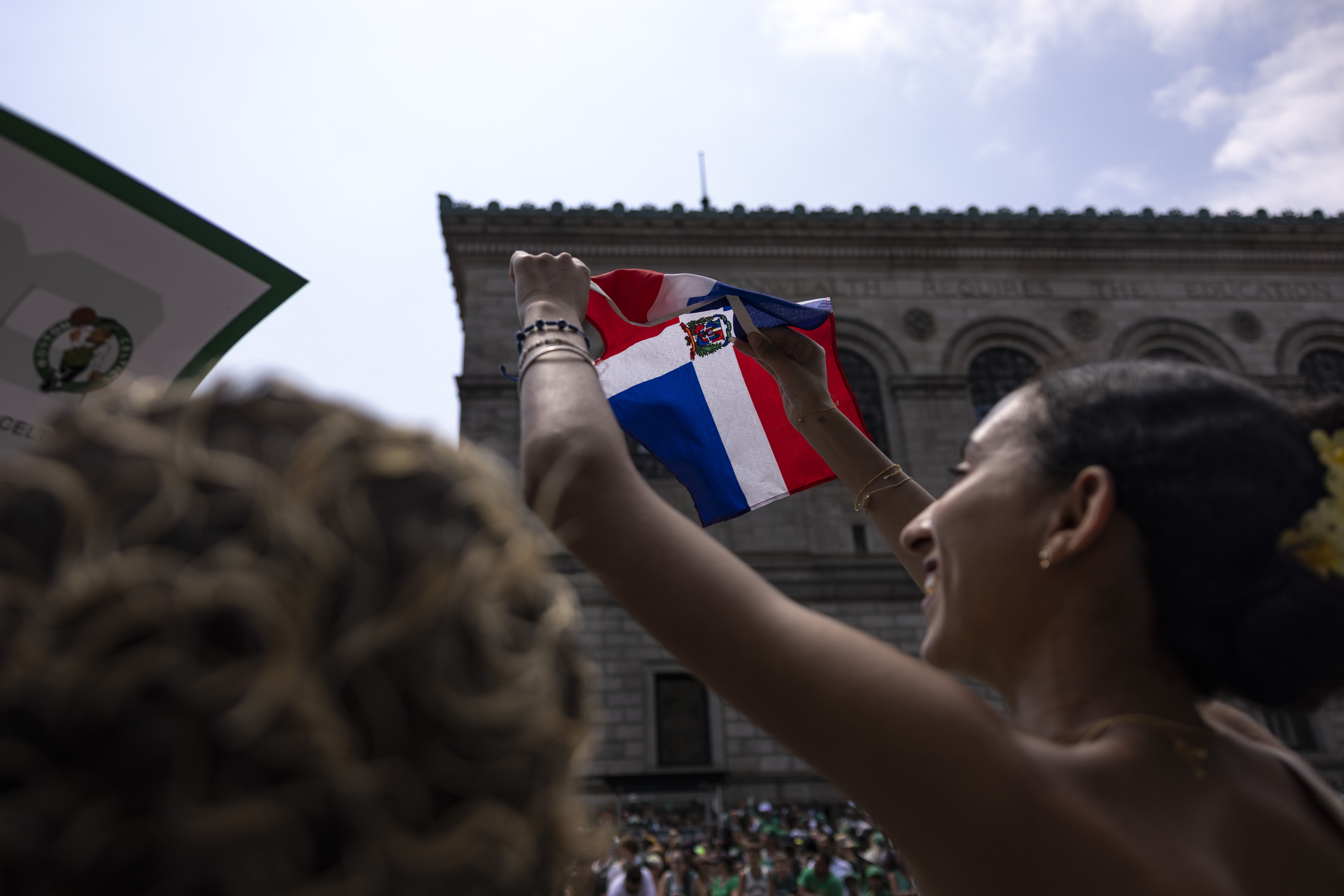 A fan waves the Dominican Republic flag during the 2024 Boston Celtics championship parade following their 2024 NBA Finals win on on June 21, 2024.