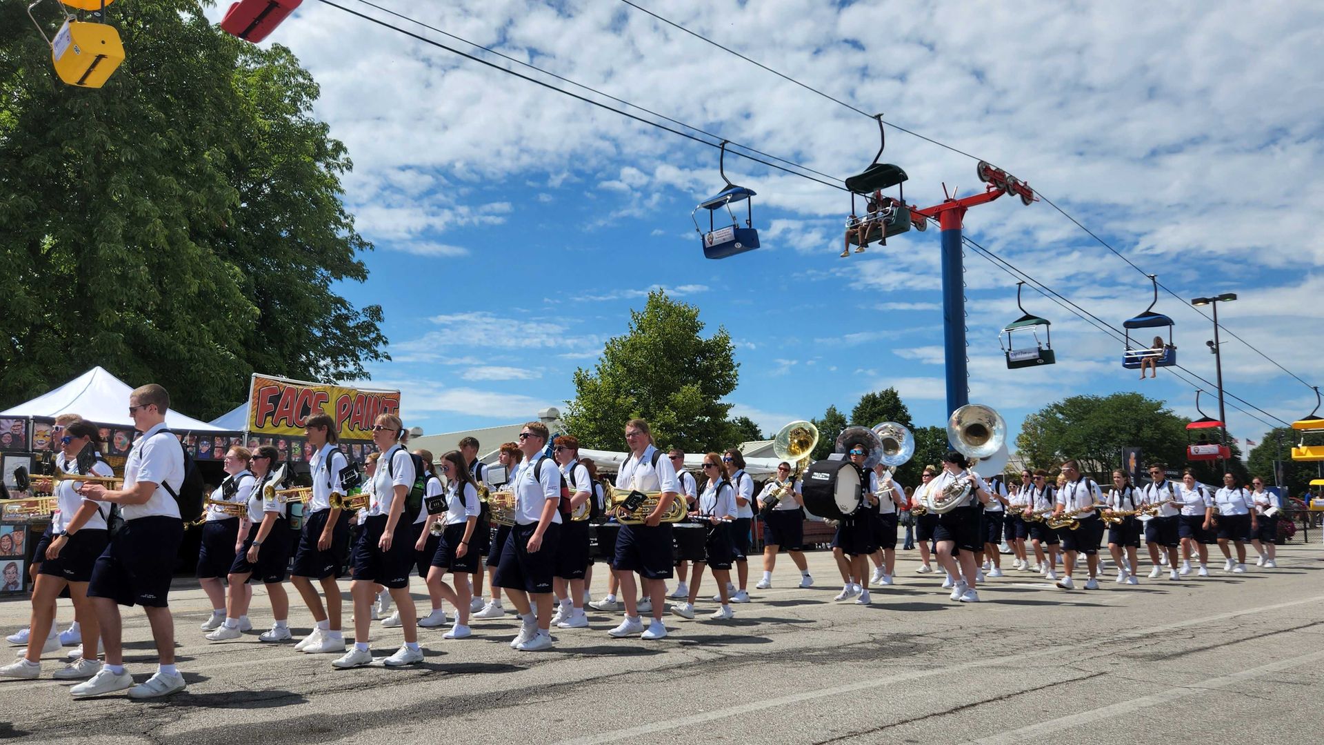 The All-Ohio state fair youth band marches down the fairground midway. 