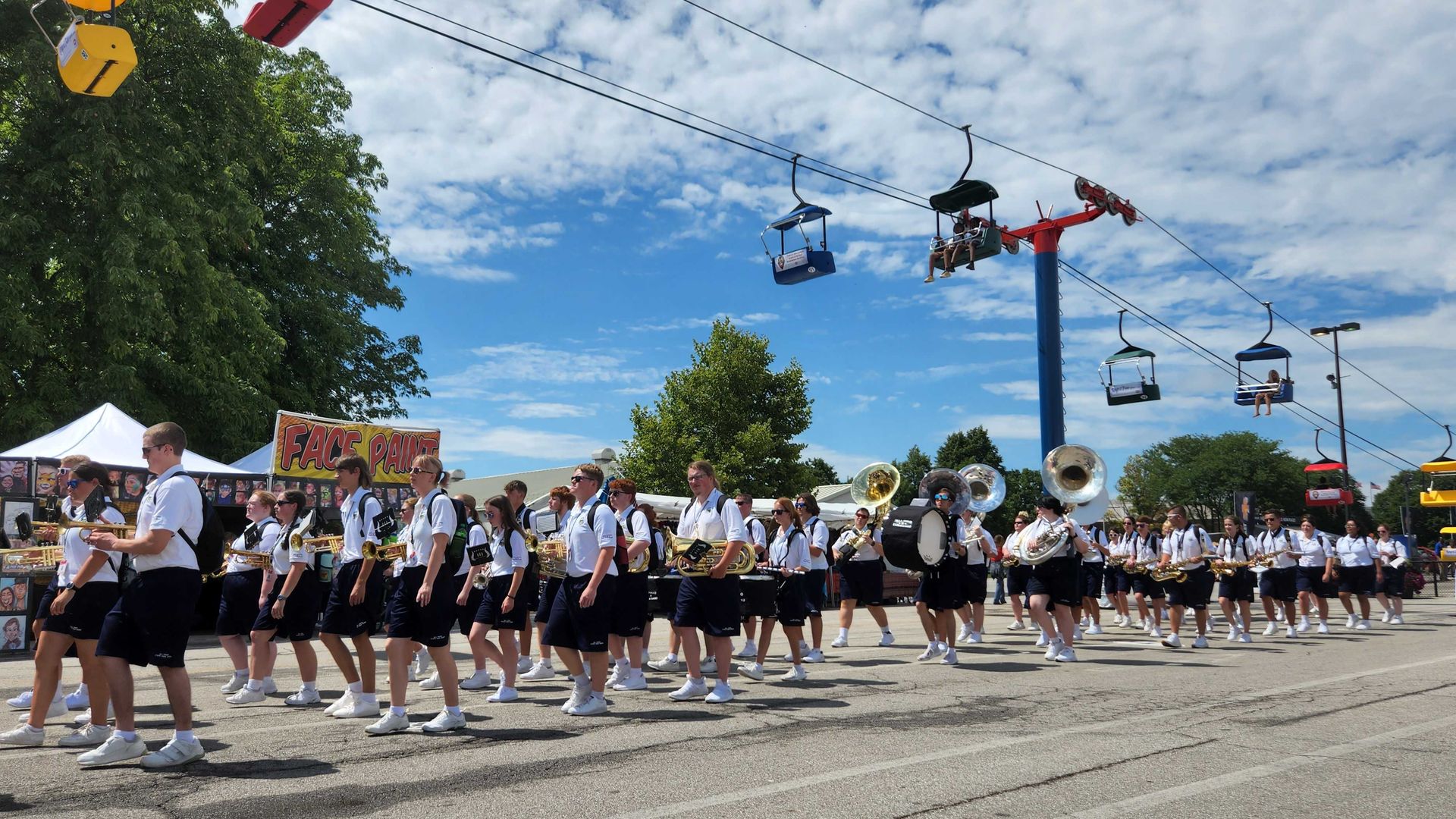 The All-Ohio state fair youth band marches down the fairground midway.