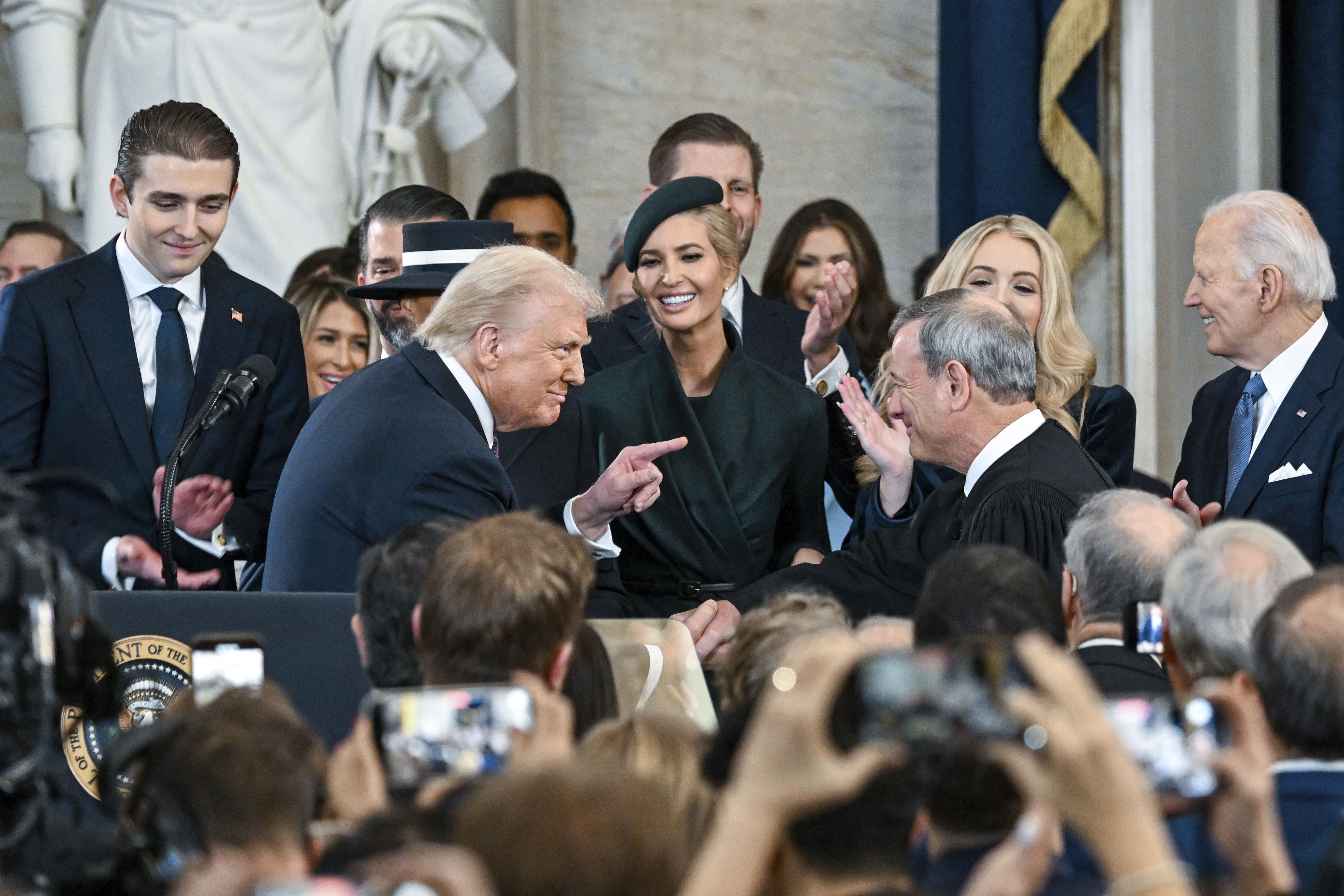 President Trump points to Chief Justice John Roberts after taking the oath of office in the Capitol Rotunda.