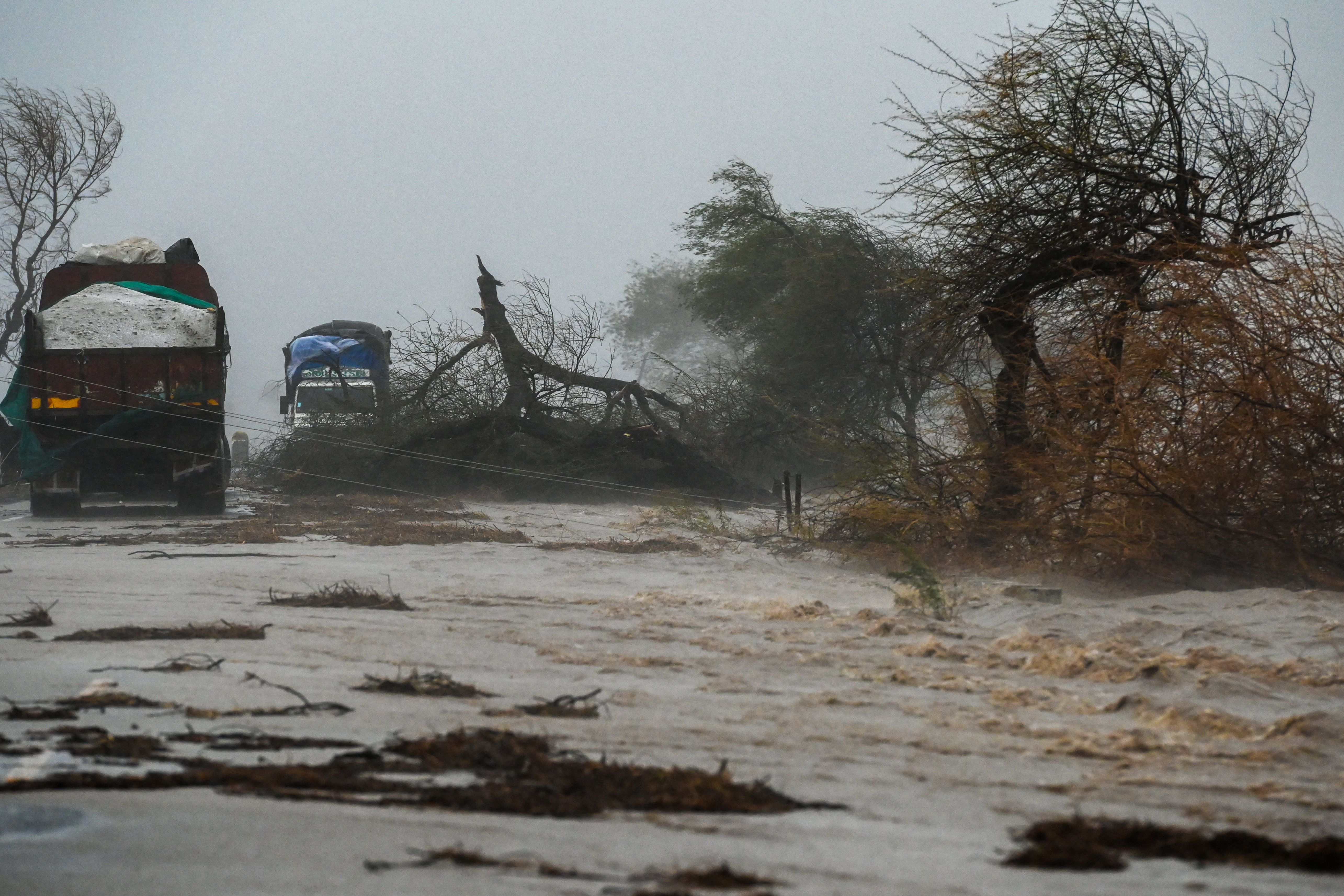  Trucks are stranded on a flooded highway near Diu on May 18, 2021,