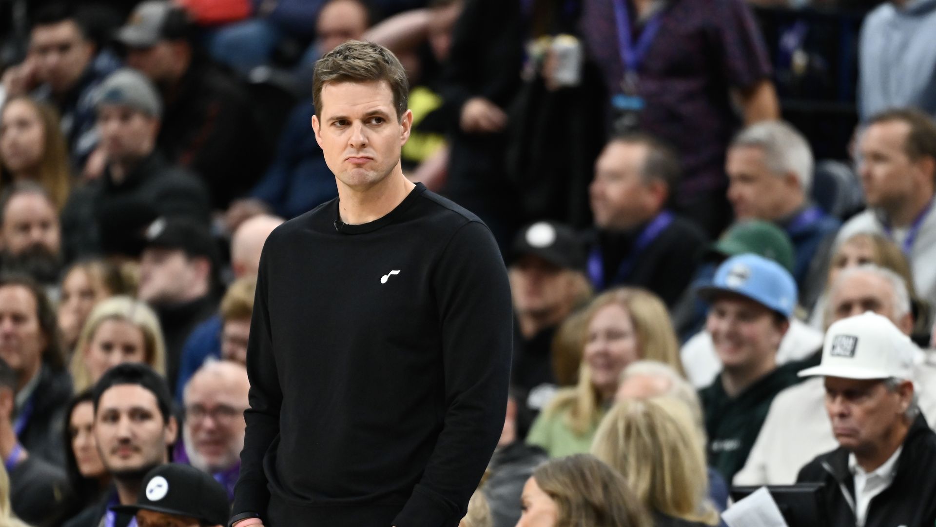 A man in a black shirt looks disappointed