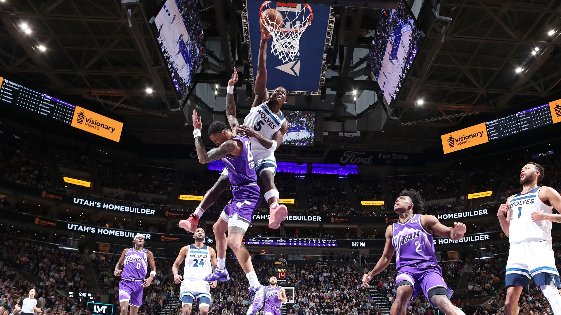 Anthony Edwards dunks a basketball over John Collins of the Utah Jazz
