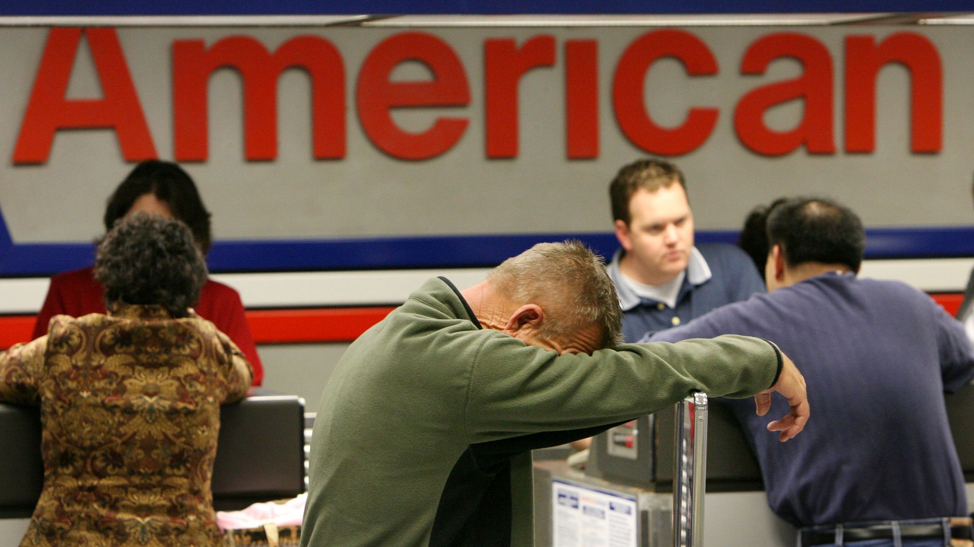 A man leans on his arm, exhausted by the world