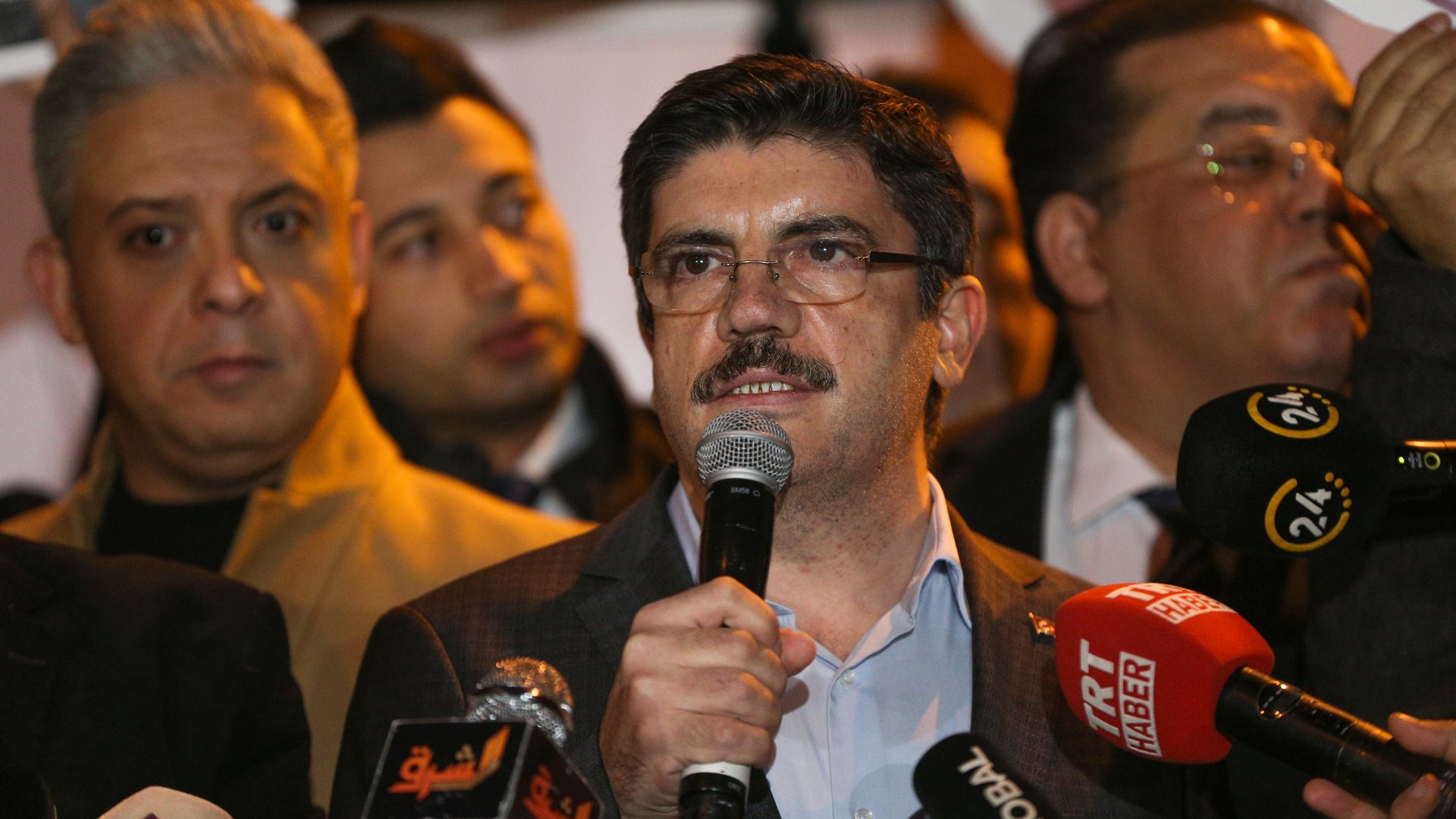 Yasin Aktay speaking to microphones.